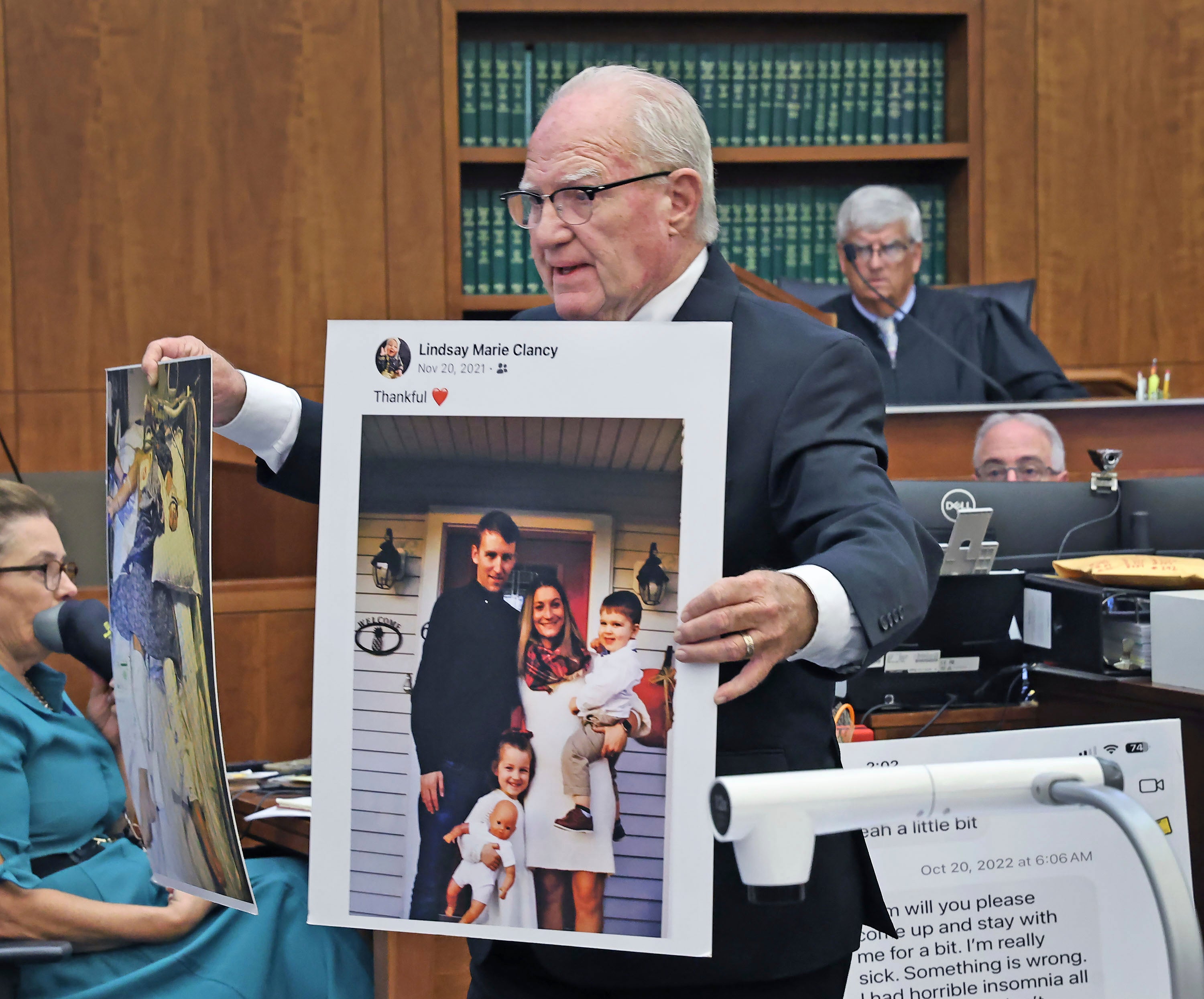 Defense attorney Kevin Reddington holds up a picture of th Clancy family before the murders during closing arguments