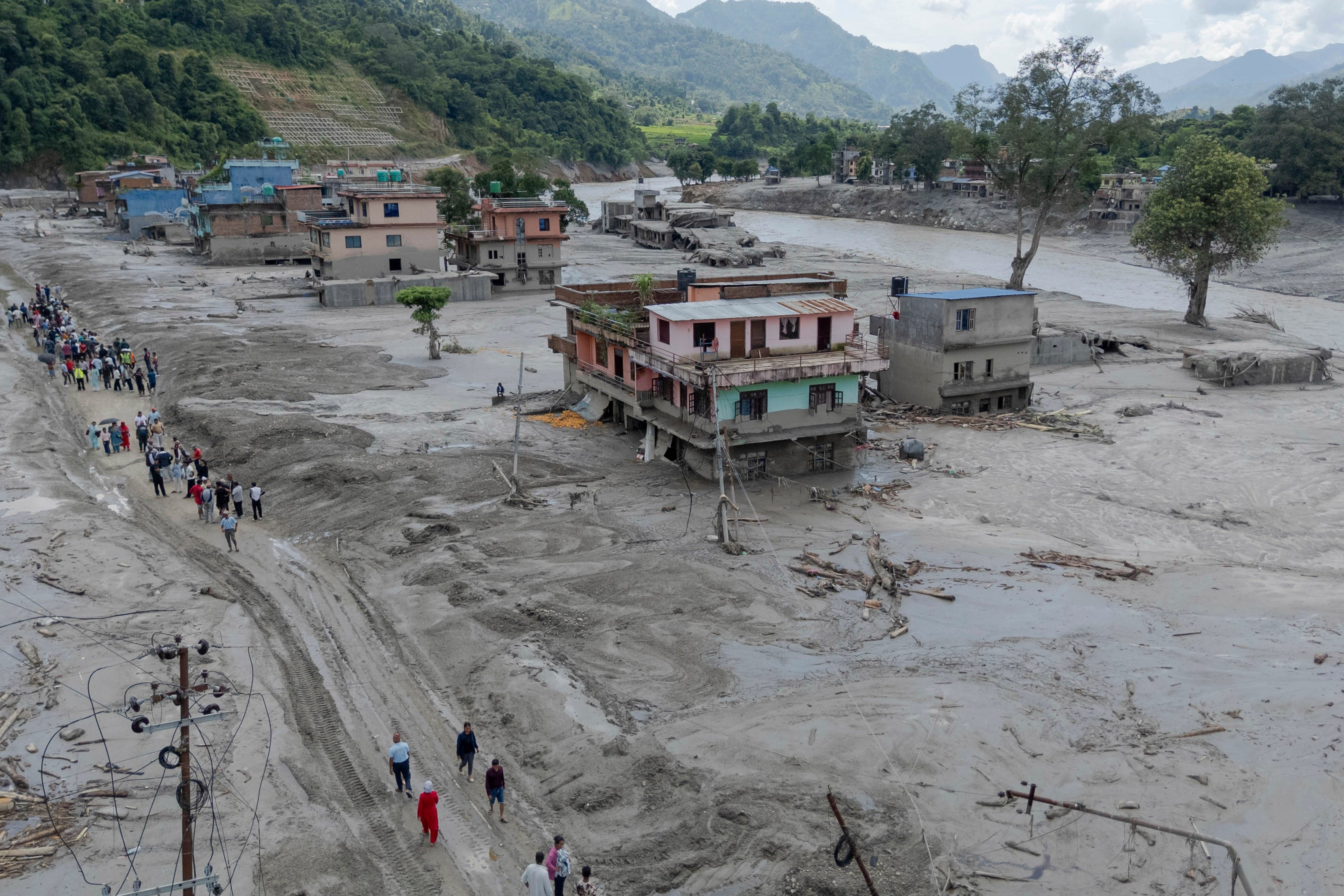 China says barrier lake on Nepal-Tibet border has already started to overflow and could cause second flash flood
