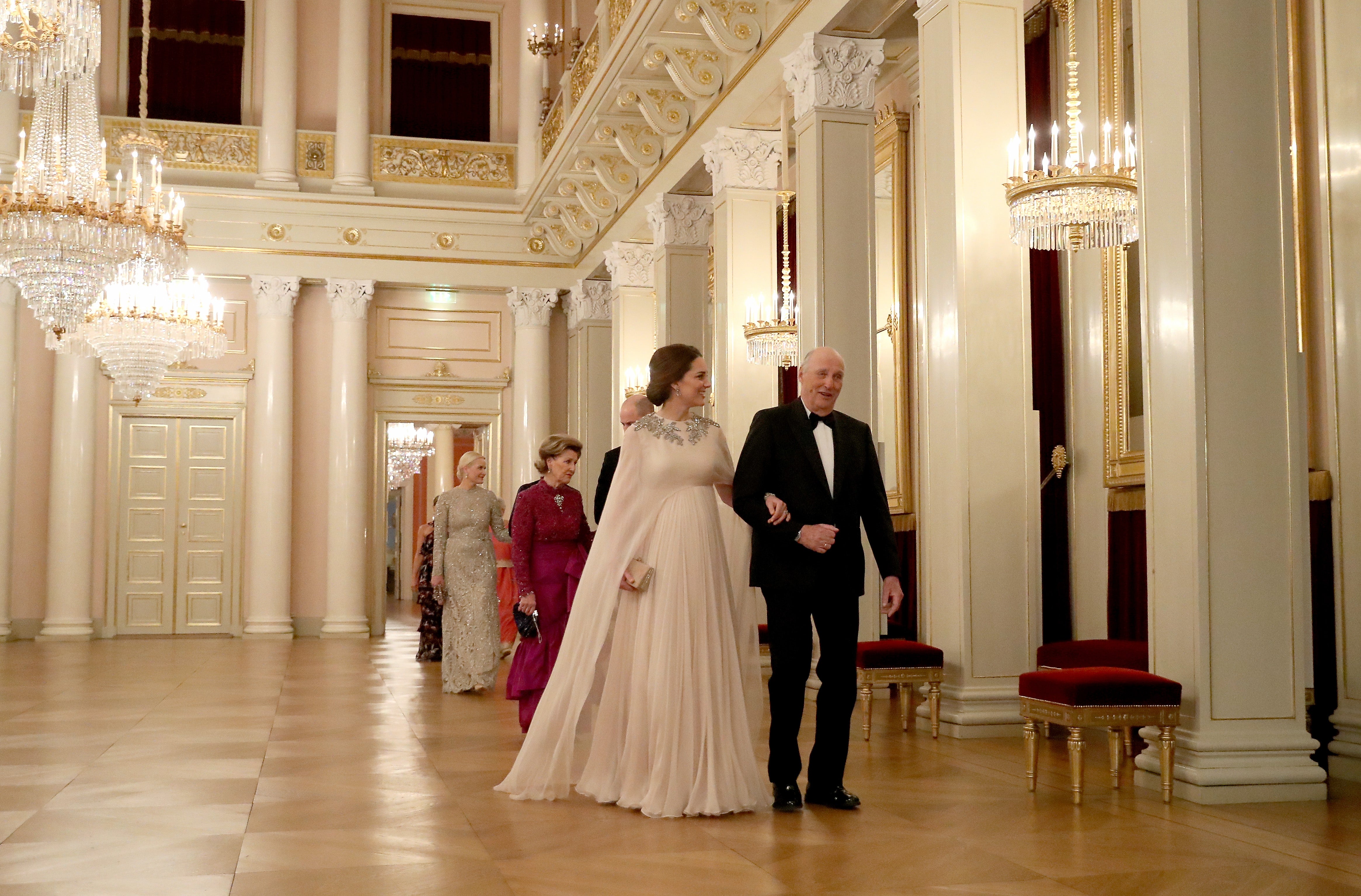 King Harald escorts Catherine, then the Duchess of Cambridge, to dinner in Oslo in 2018