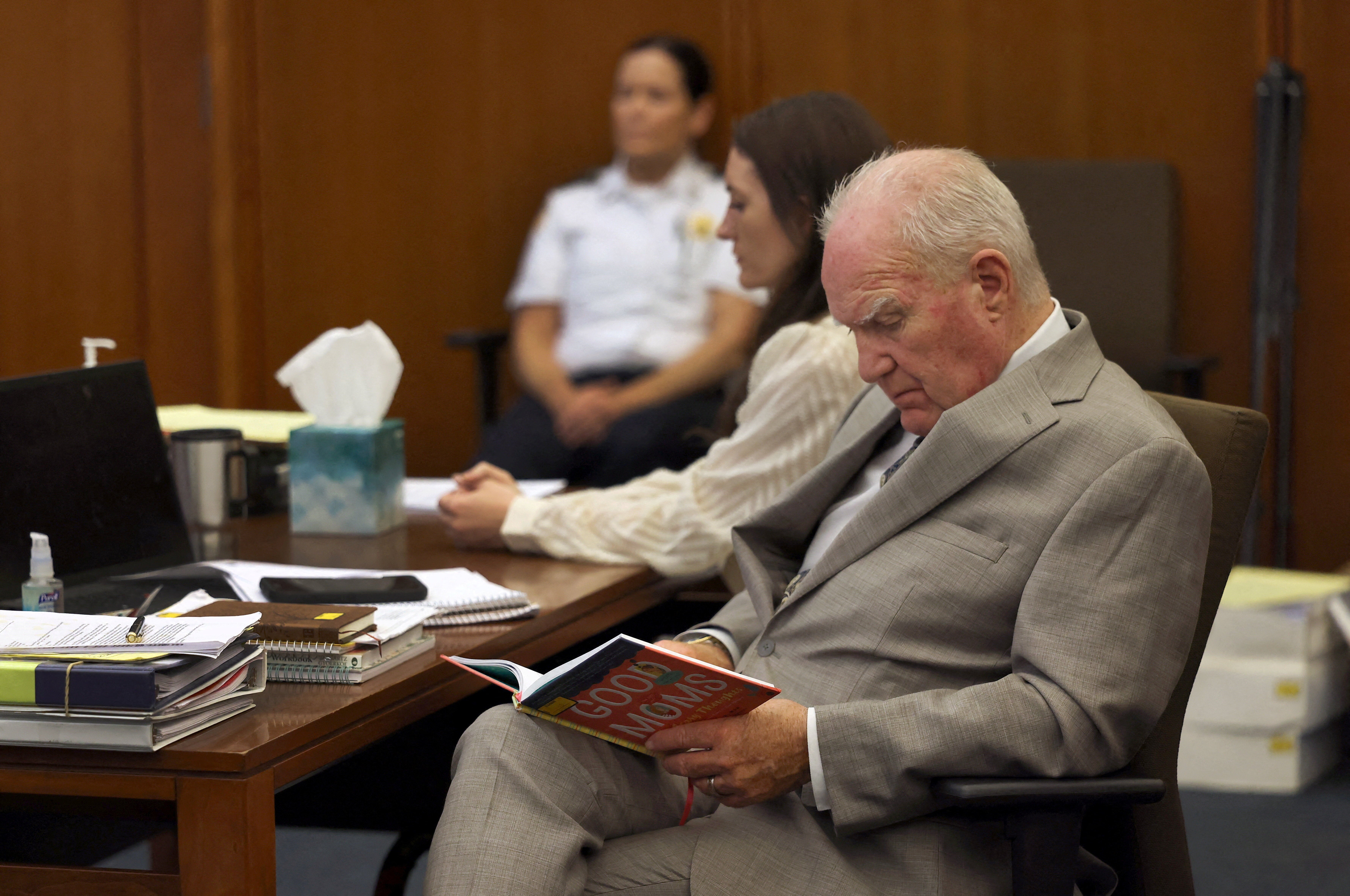 Lindsay Clancy sits beside her defense attorney Kevin Reddington as he looks over a book titled "Good Moms Have Scary Thoughts"
