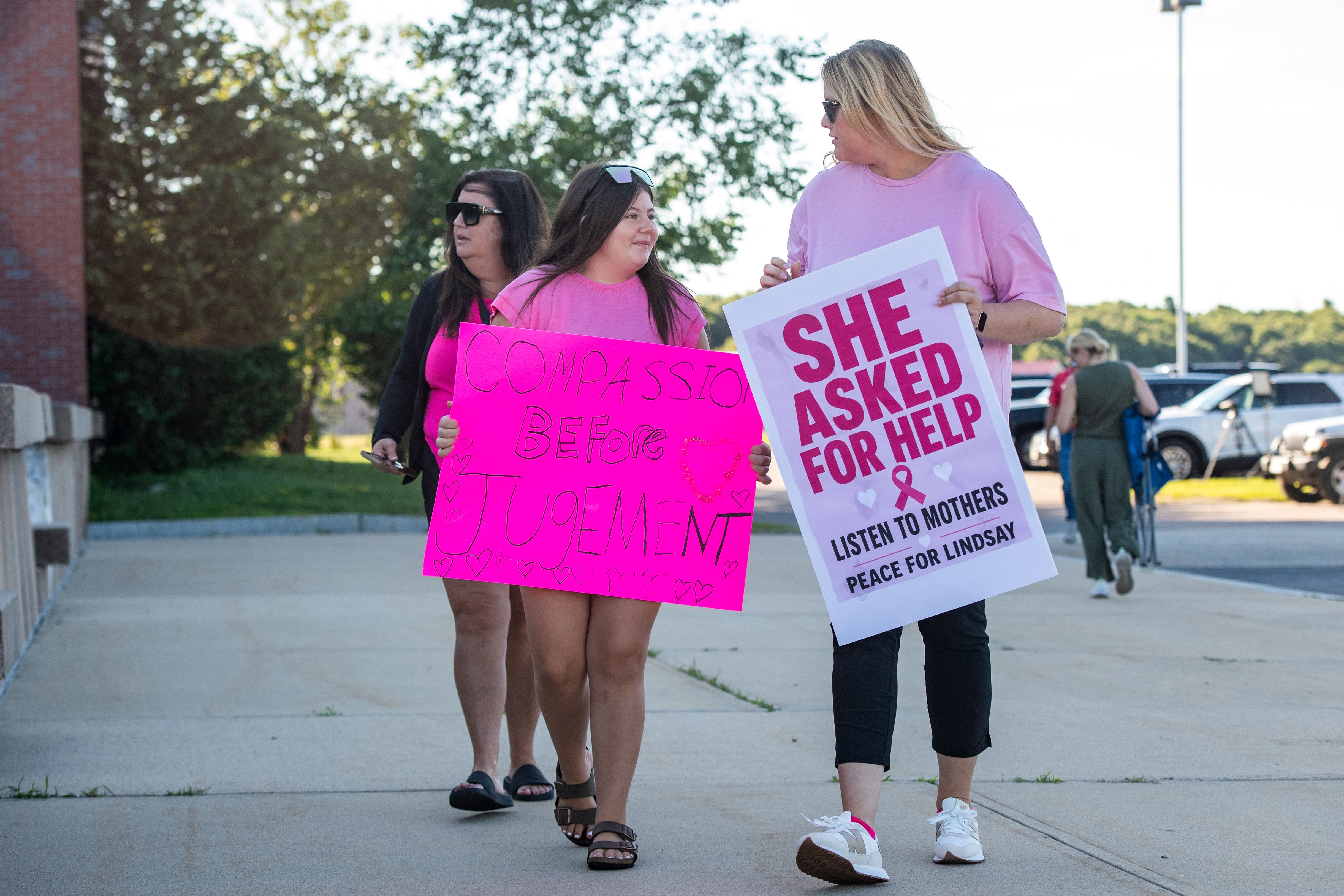 Supporters of Lindsay Clancy hold signs outside the Plymouth County Superior Court