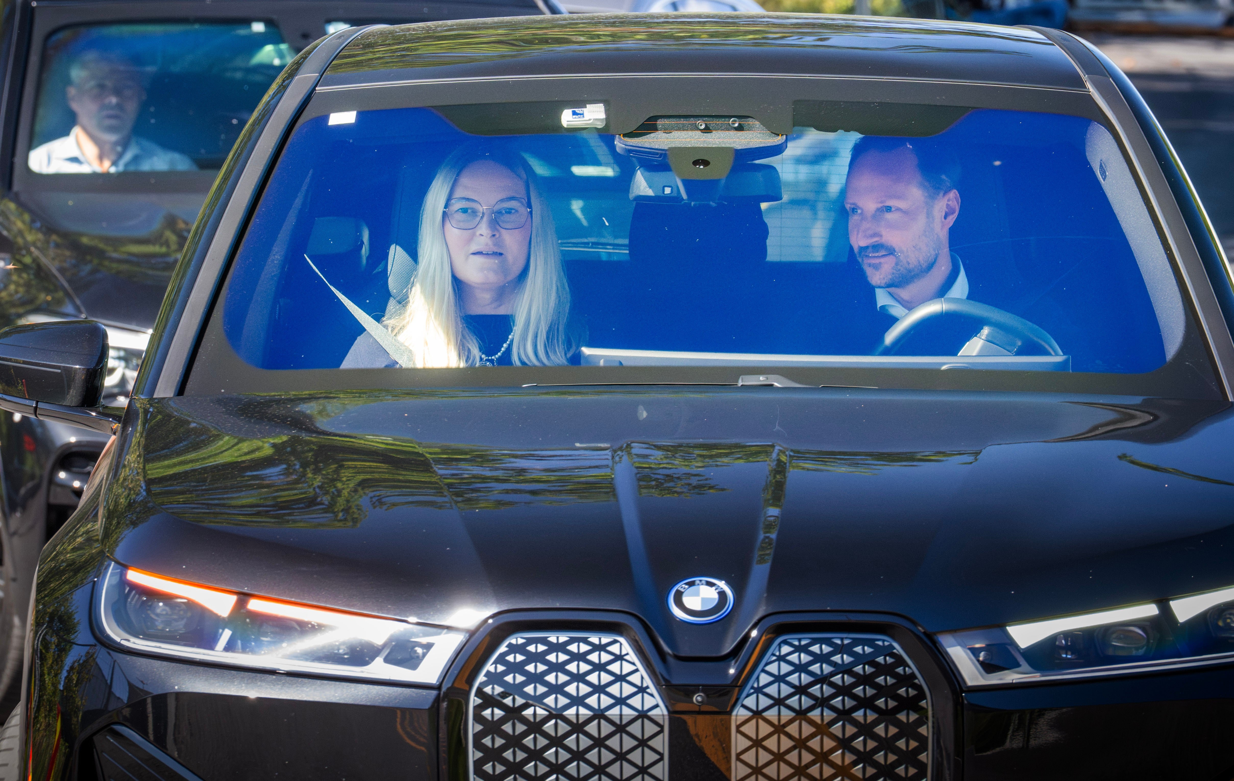 Haakon and Mette-Marit leave the hospital after visiting King Harald (AP)