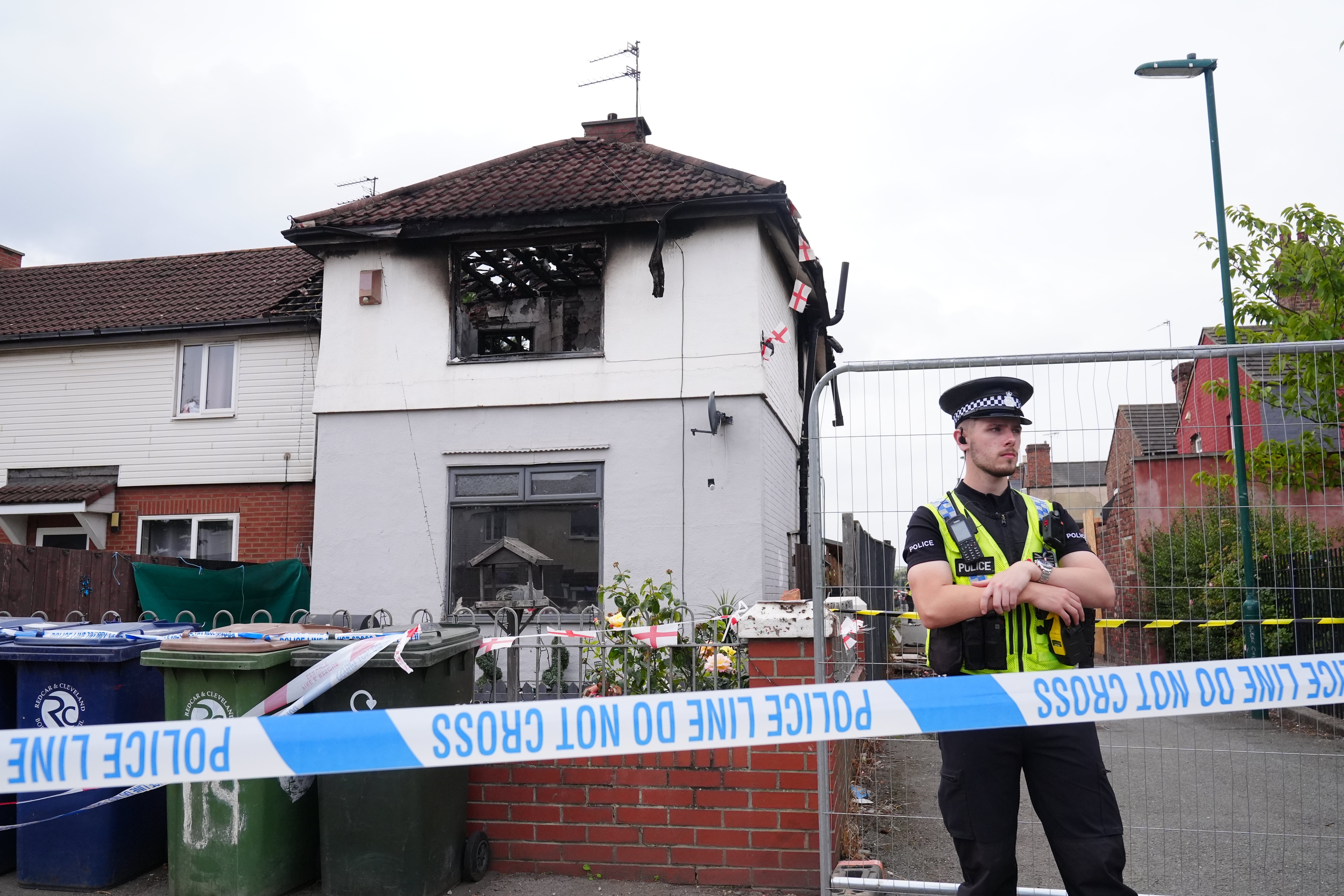 Police officers at the scene on Birchington Avenue, Grangetown, near Middlesbrough, where Valentina Foster, aged seven, and Natalie McDonald, 34, died following a fire (PA Wire)
