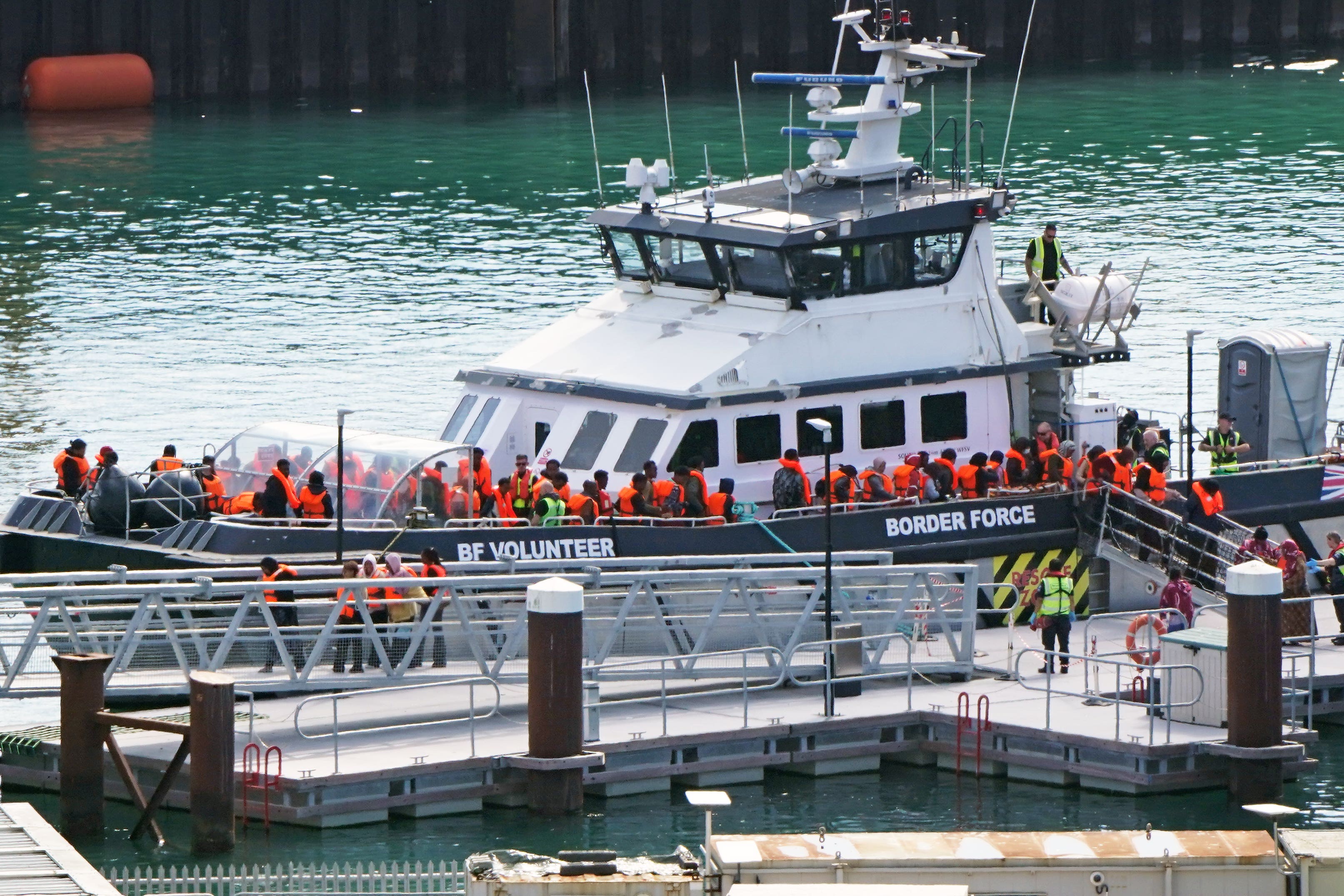 A group of people thought to be migrants are brought into the Border Security Command compound in Dover, Kent, on Thursday (Gareth Fuller/PA)