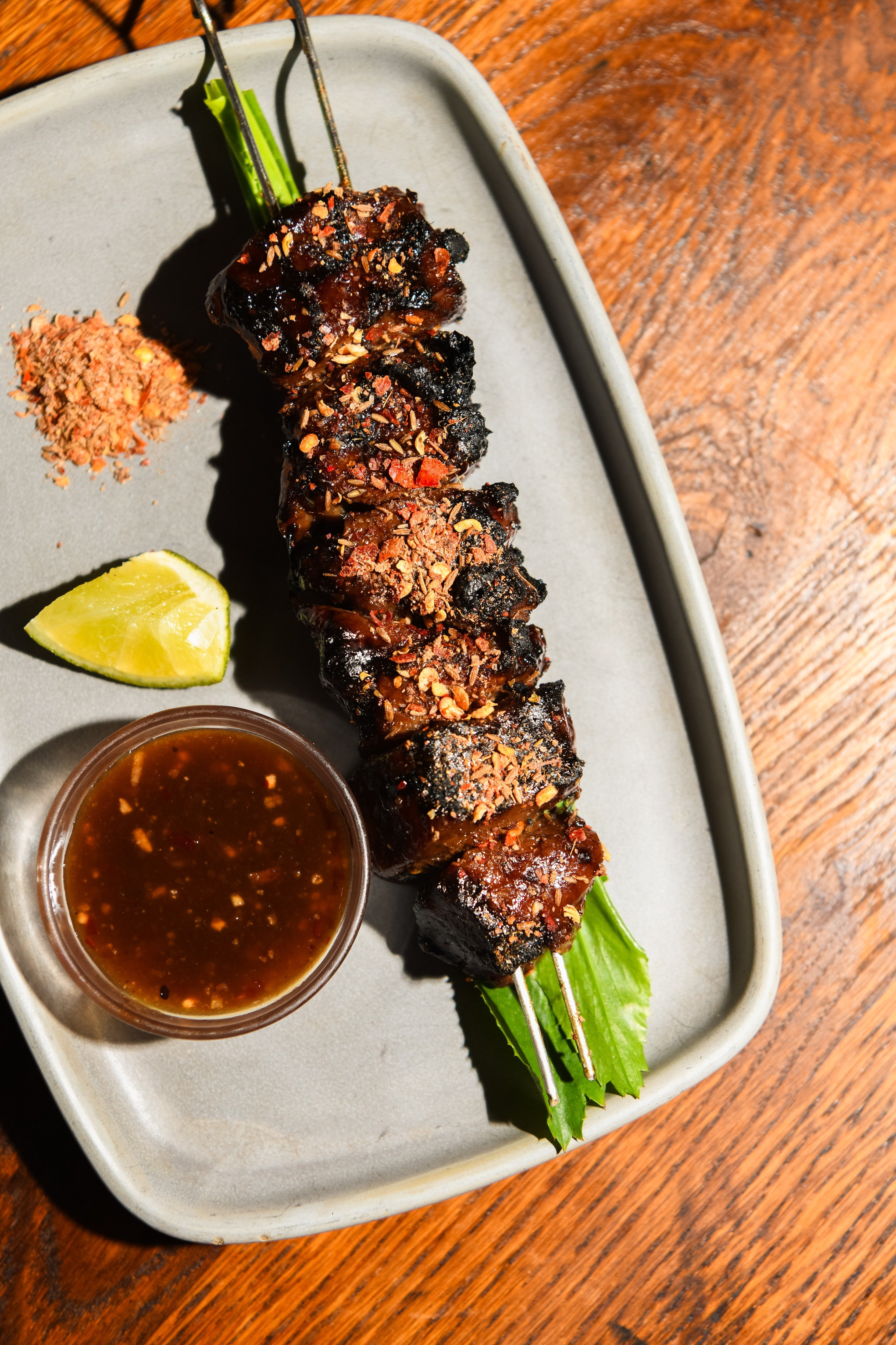 Moo ping pork skewers, sweet, smoky and caramelised at the edges