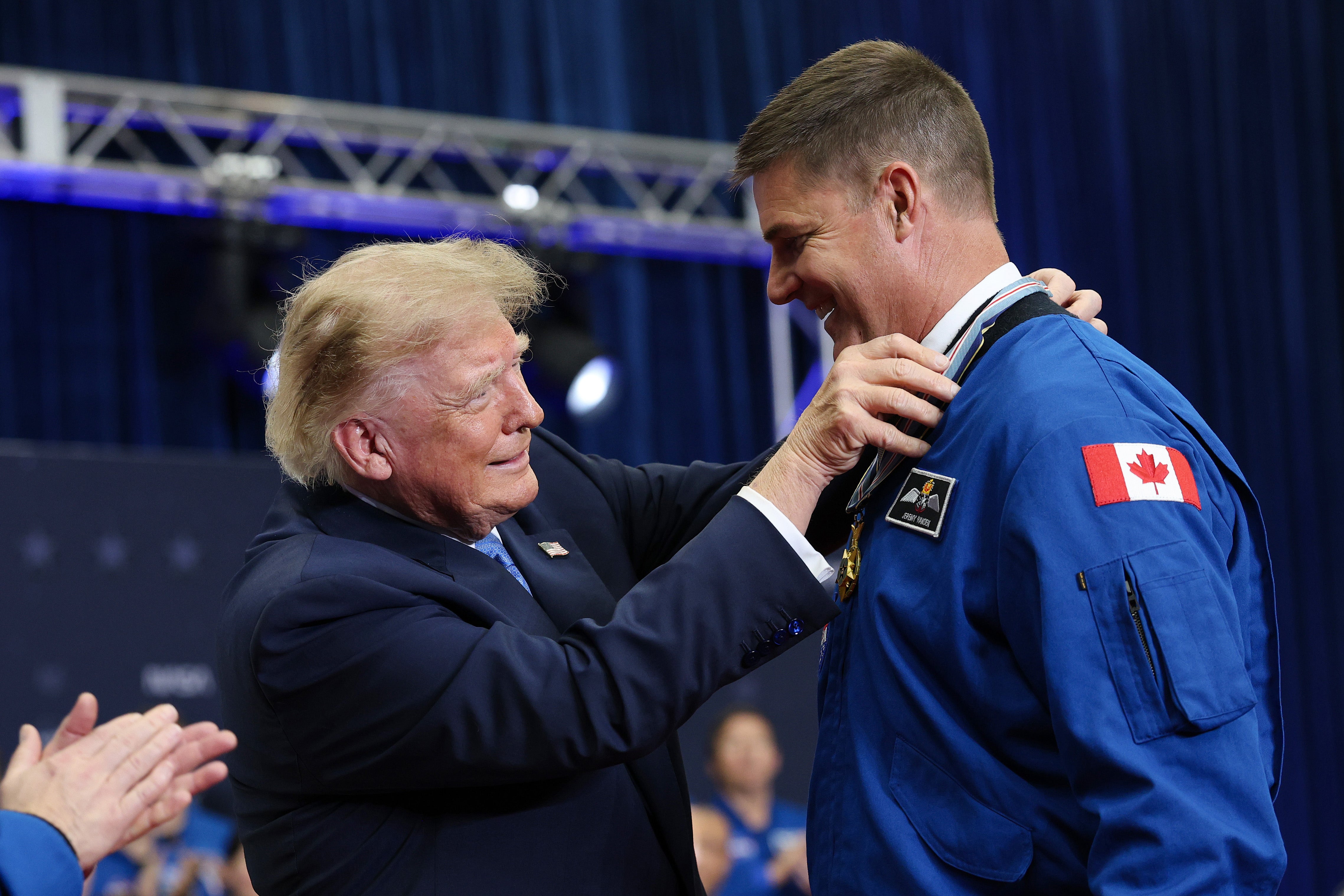 Trump shows up nearly half-hour late and announces yet another construction project before he honors Artemis astronauts