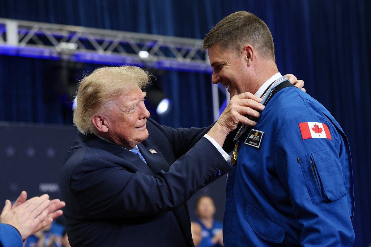 Trump shows up nearly half-hour late and announces yet another construction project before he honors Artemis astronauts