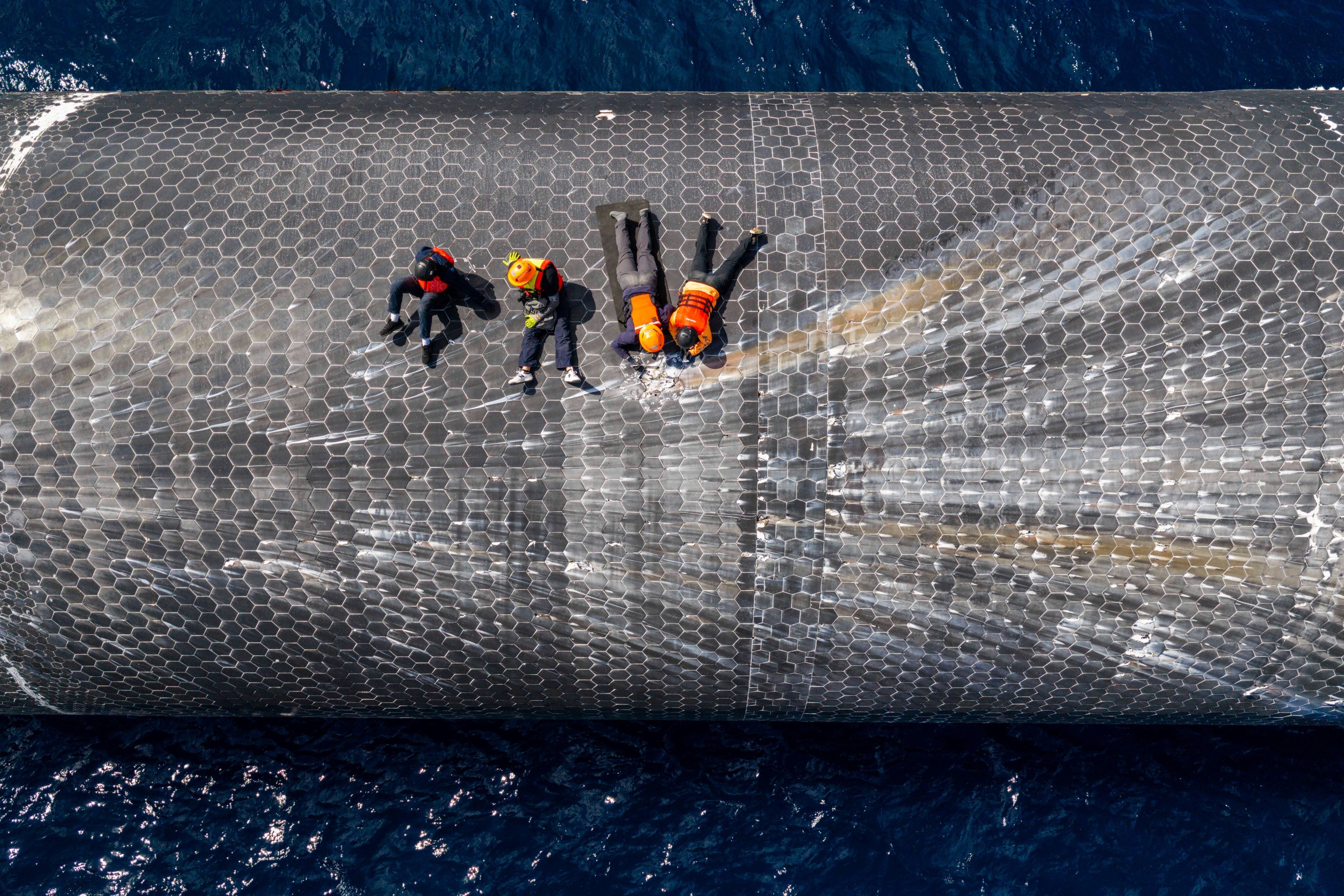 Engineers inspecting the Starship off the coast of Christmas Island in the Indian Ocean