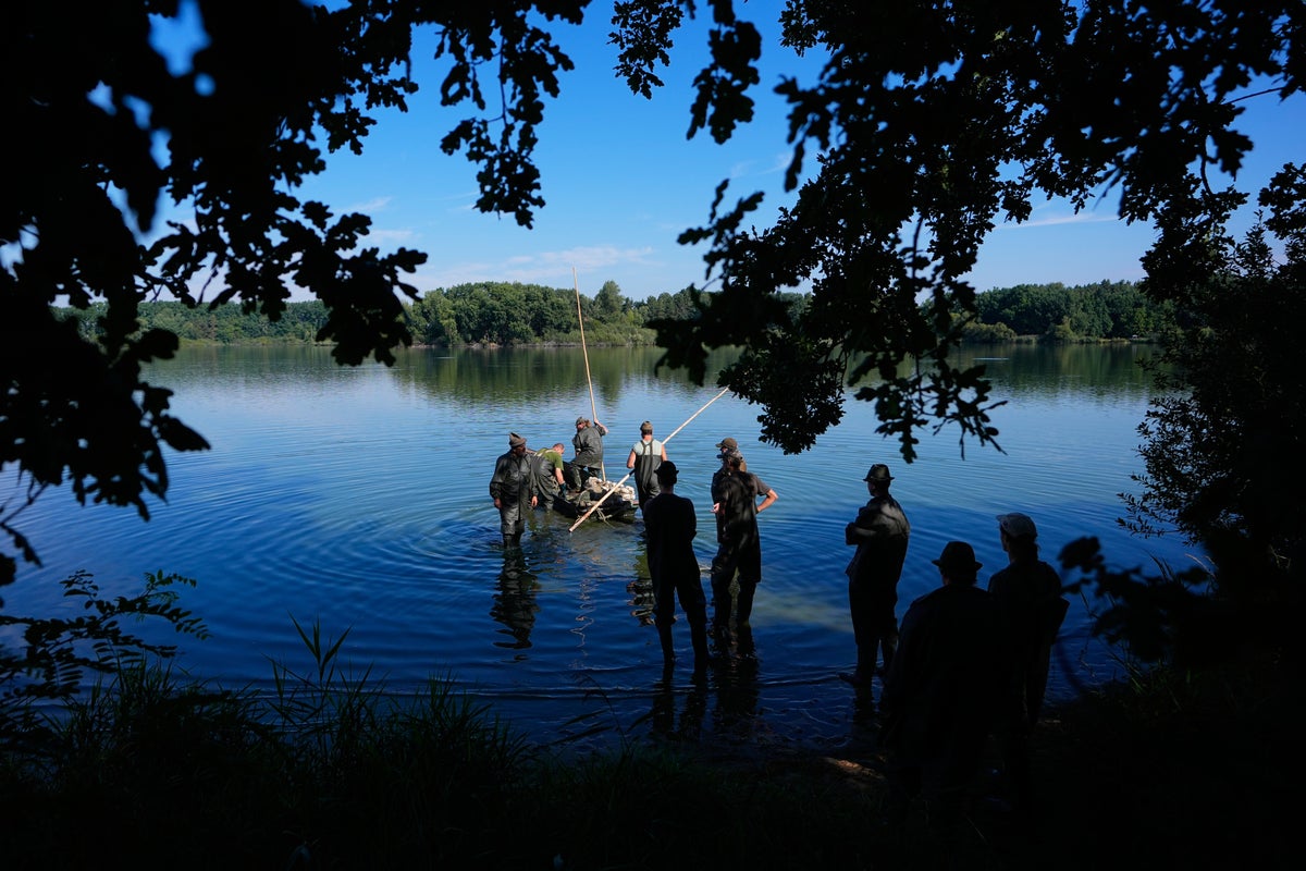 Photos show European fishers on the brink as summer drought parches rivers, lakes and farms Photos show European fishers on the brink as summer drought parches rivers, lakes and farms