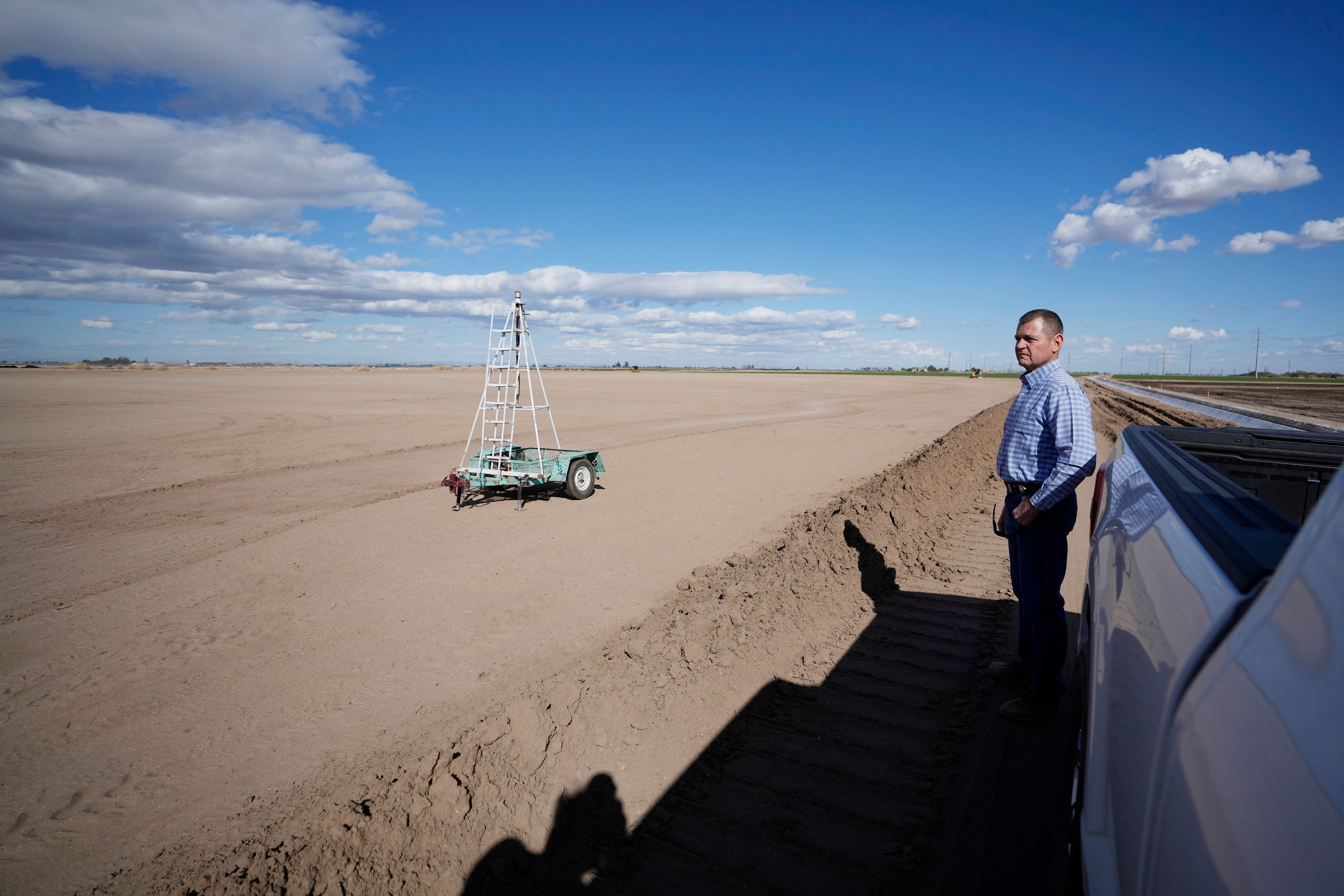 Tom Brundy looks over his field that is being prepared for planting near Calexico, California