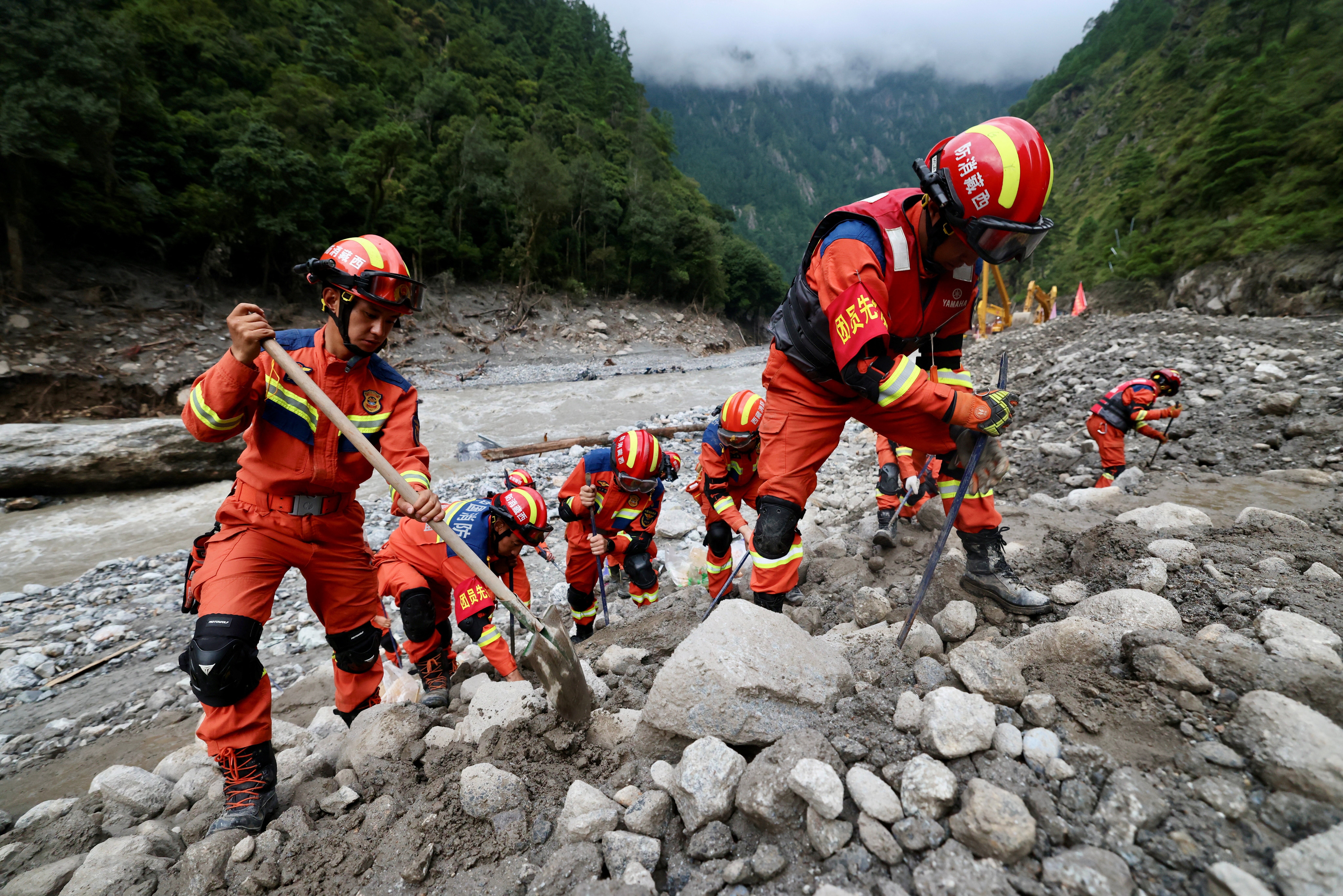 Rescue workers clear debris during search operations near the Gyirong port after a mudslide, in Shigatse, Tibet Autonomous Region, China August 29, 2026.