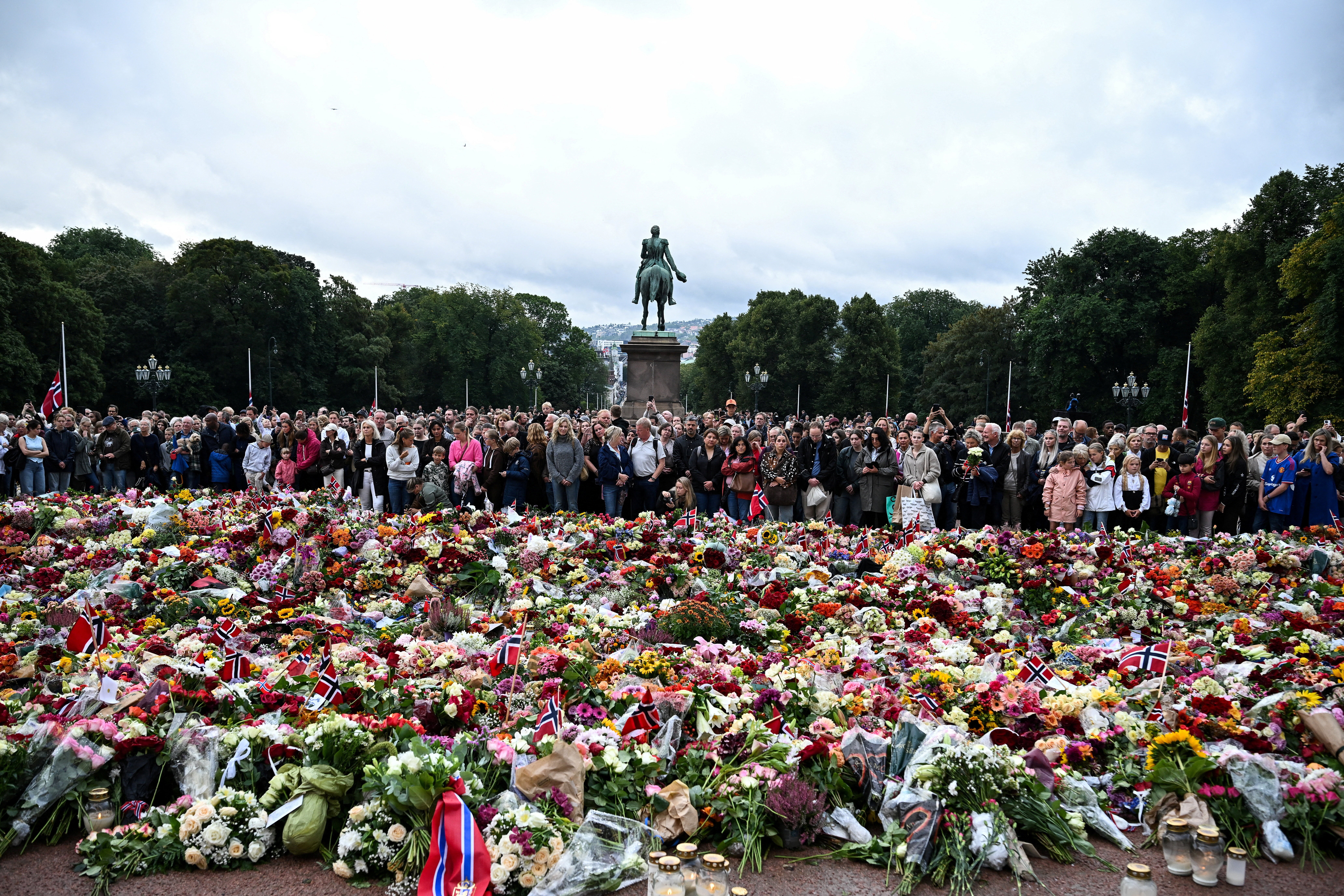 People gather to pay their respects outside the Royal Palace, following the death of Norway's King Harald