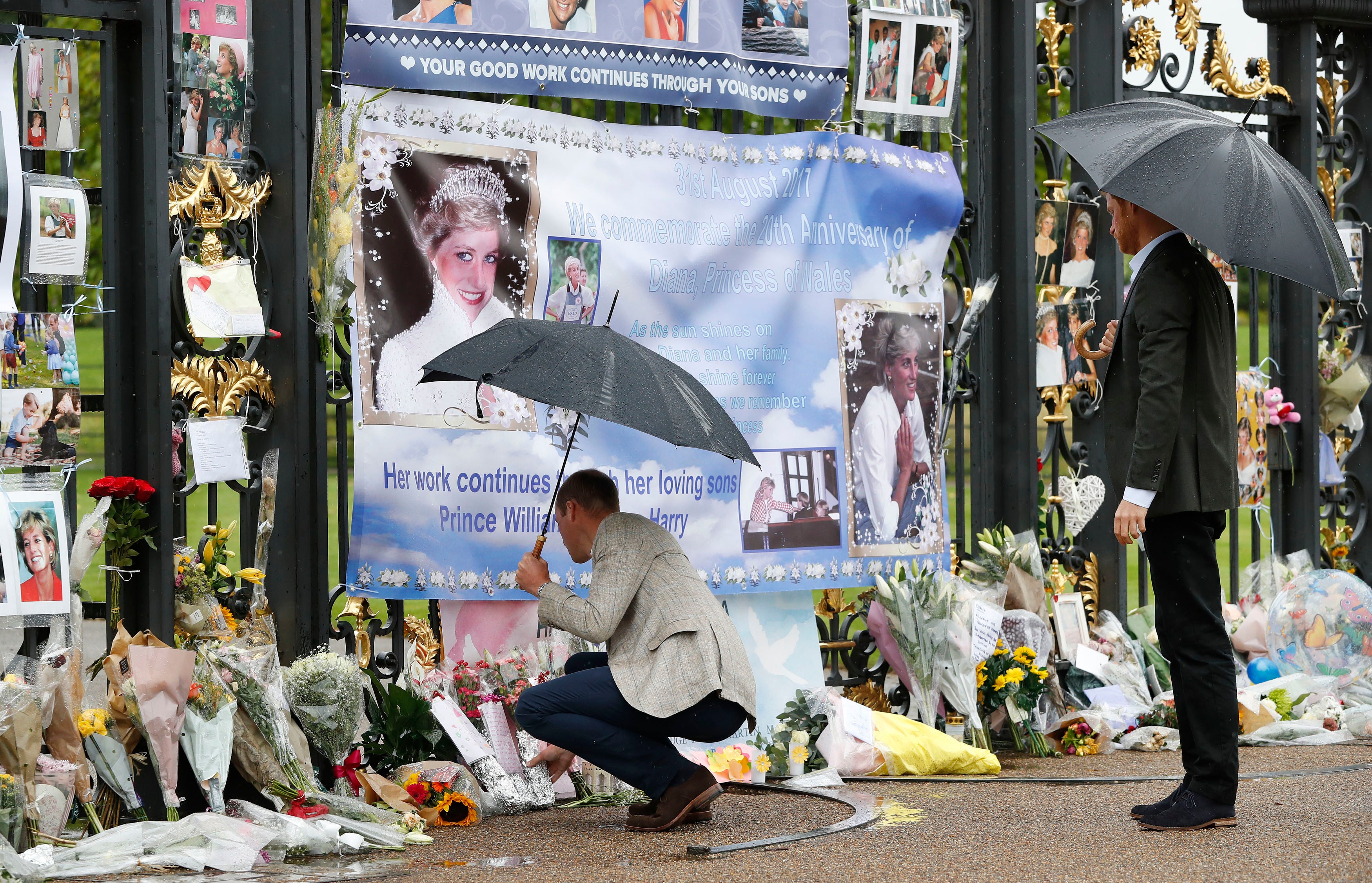 William leaves flowers as he and Harry look at tributes to Diana, Princess of Wales attached to gates of Kensington Palace ahead of the 20th anniversary in 2017