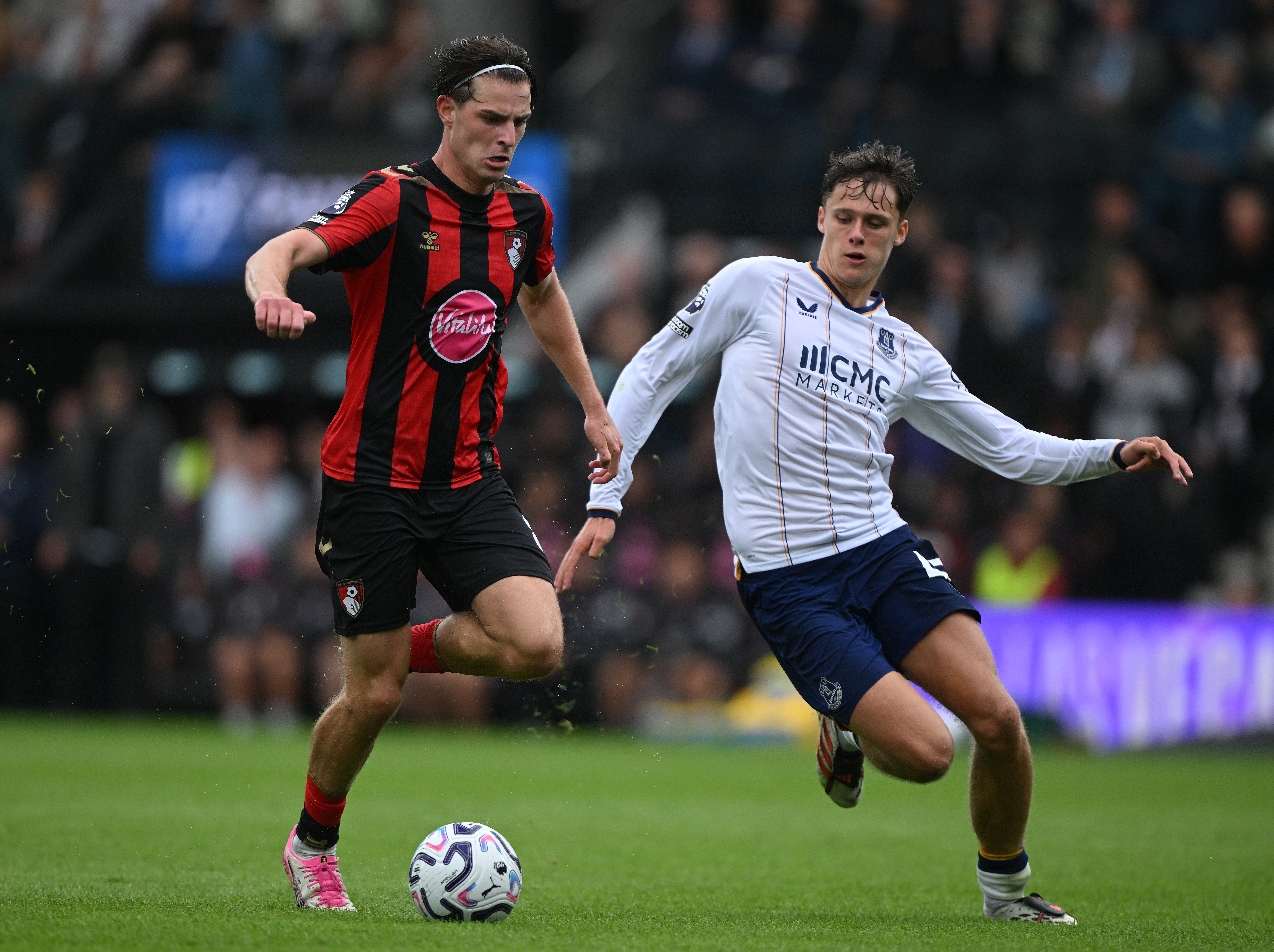 Alex Scott of Bournemouth is challenged by Harrison Armstrong of Everton