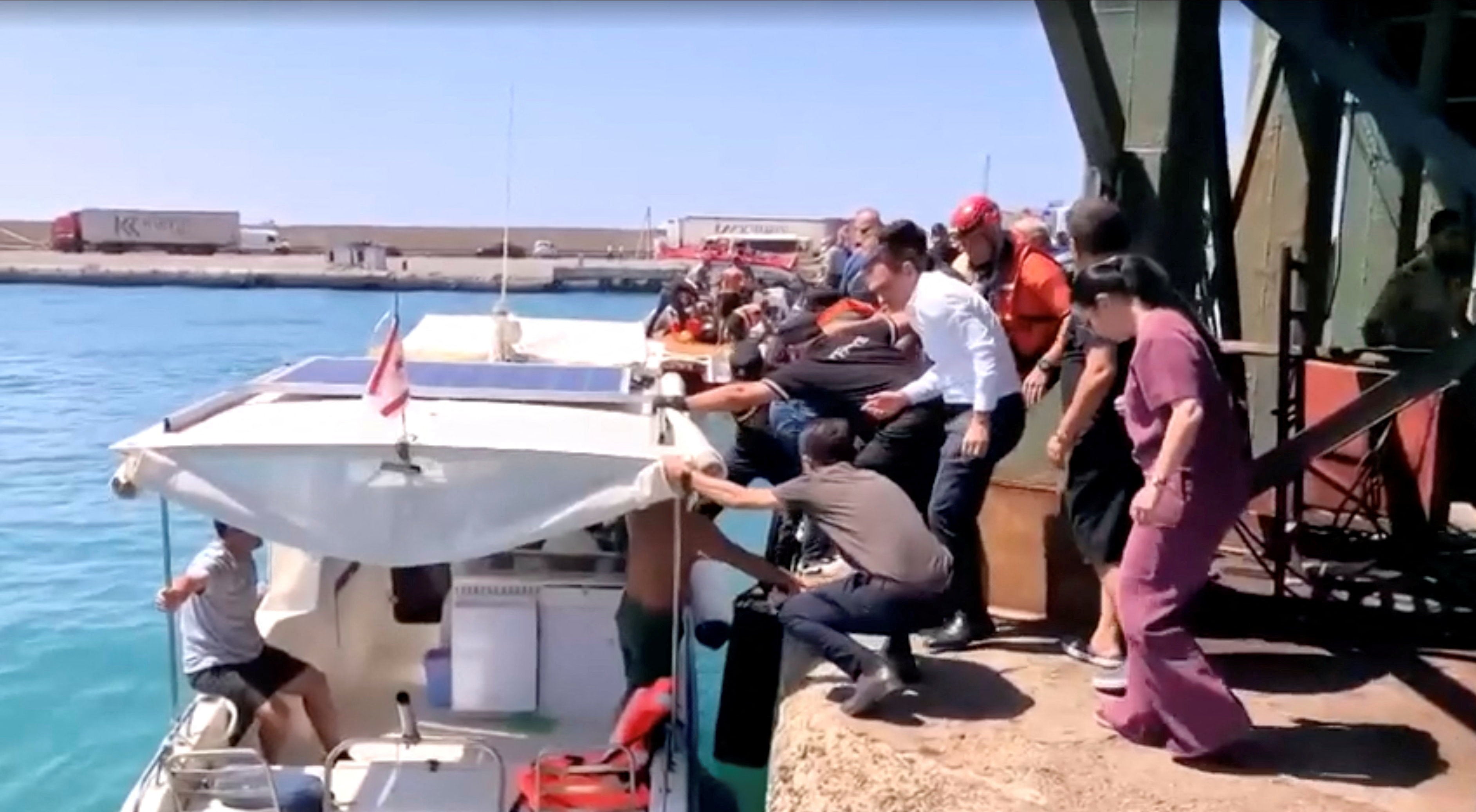 Rescue boats bring passengers to shore from capsized boat in northern Cyprus
