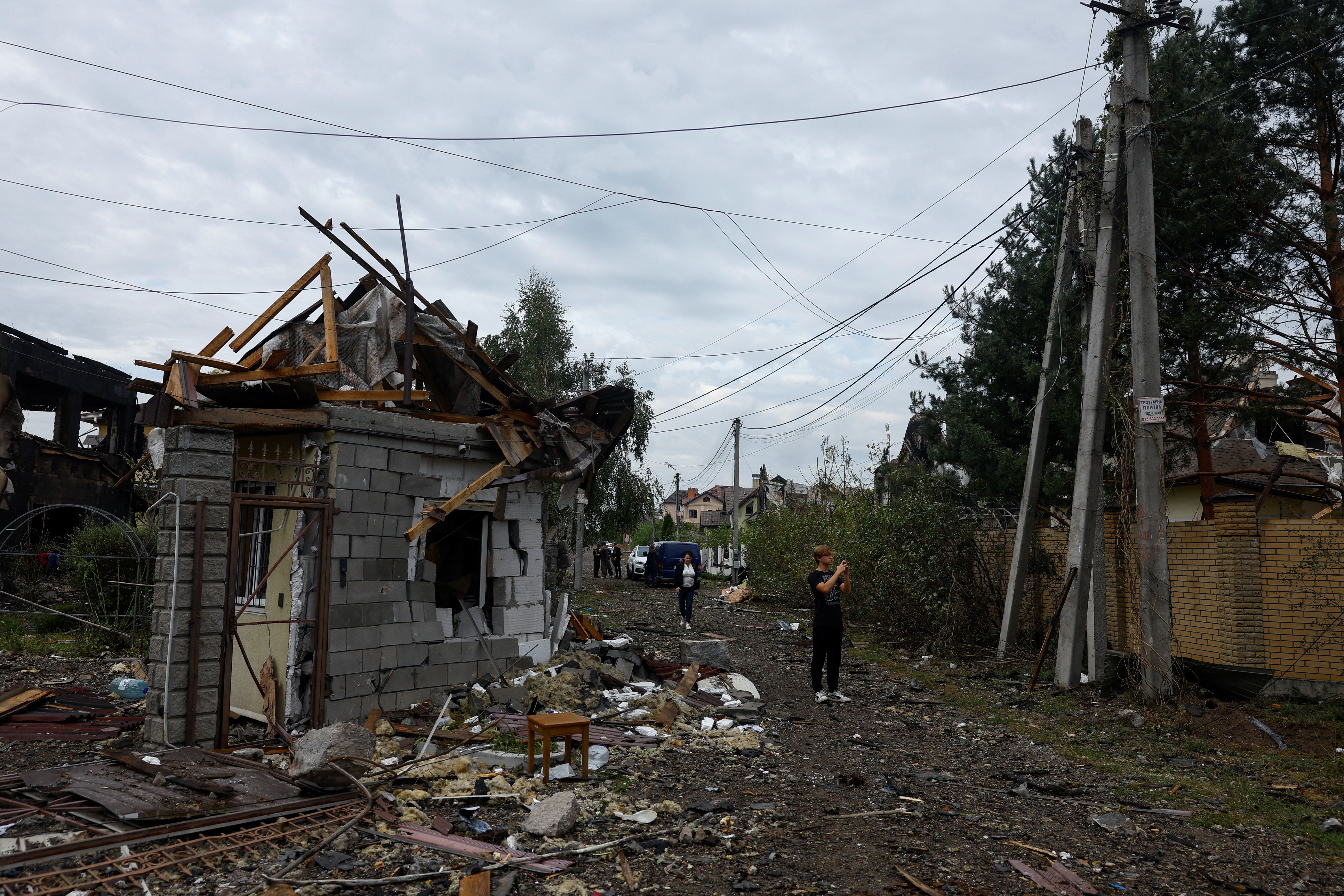 Residents next to private houses damaged by Russian drone strikes on Friday evening, amid Russia's attack on Ukraine, in Kyiv region, Ukraine August 30, 2026. (Reuters)