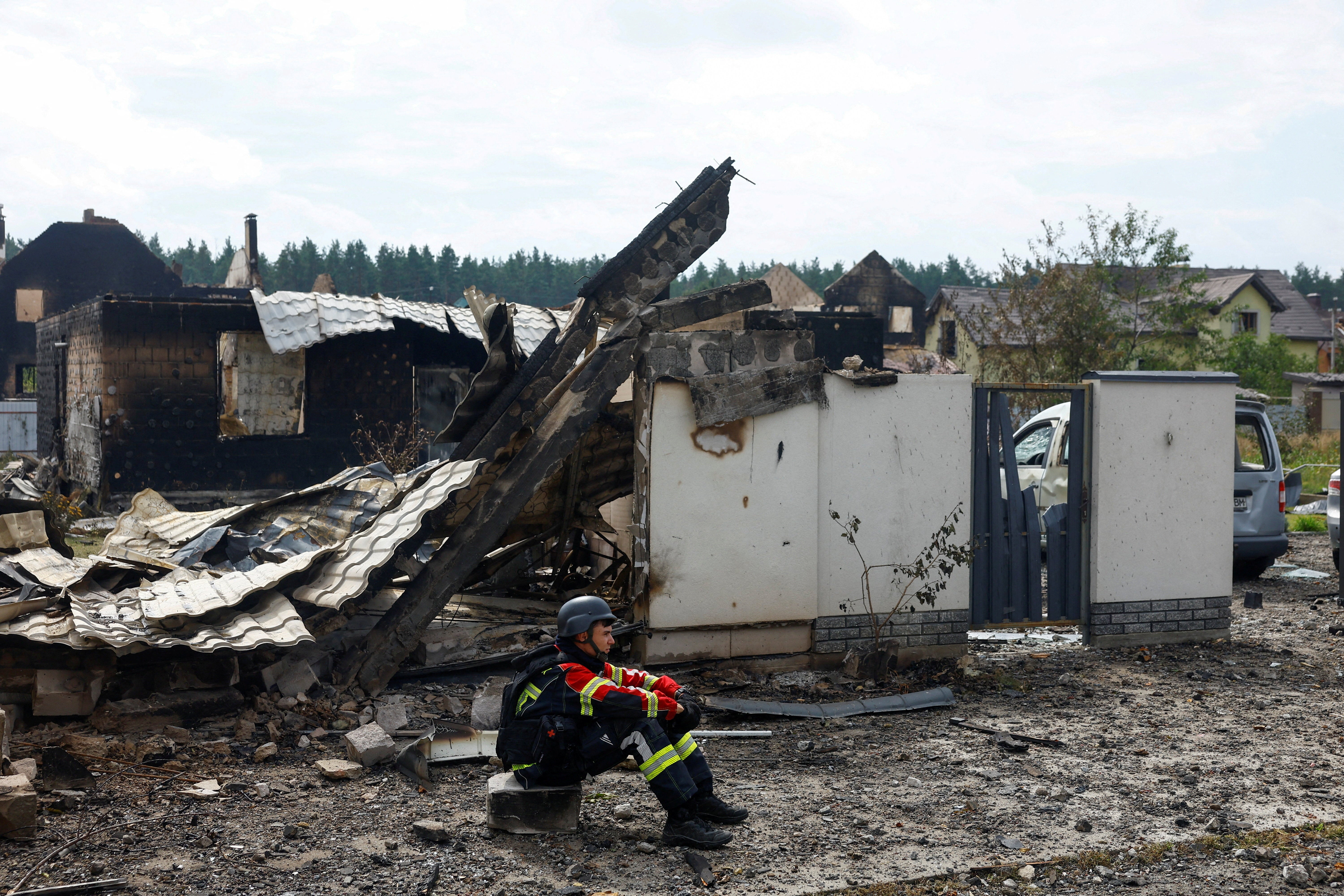 A rescuer rests next to a private house damaged by Russian drone strikes on Friday evening, amid Russia's attack on Ukraine, in Kyiv region, Ukraine August 30, 2026. (Reuters)