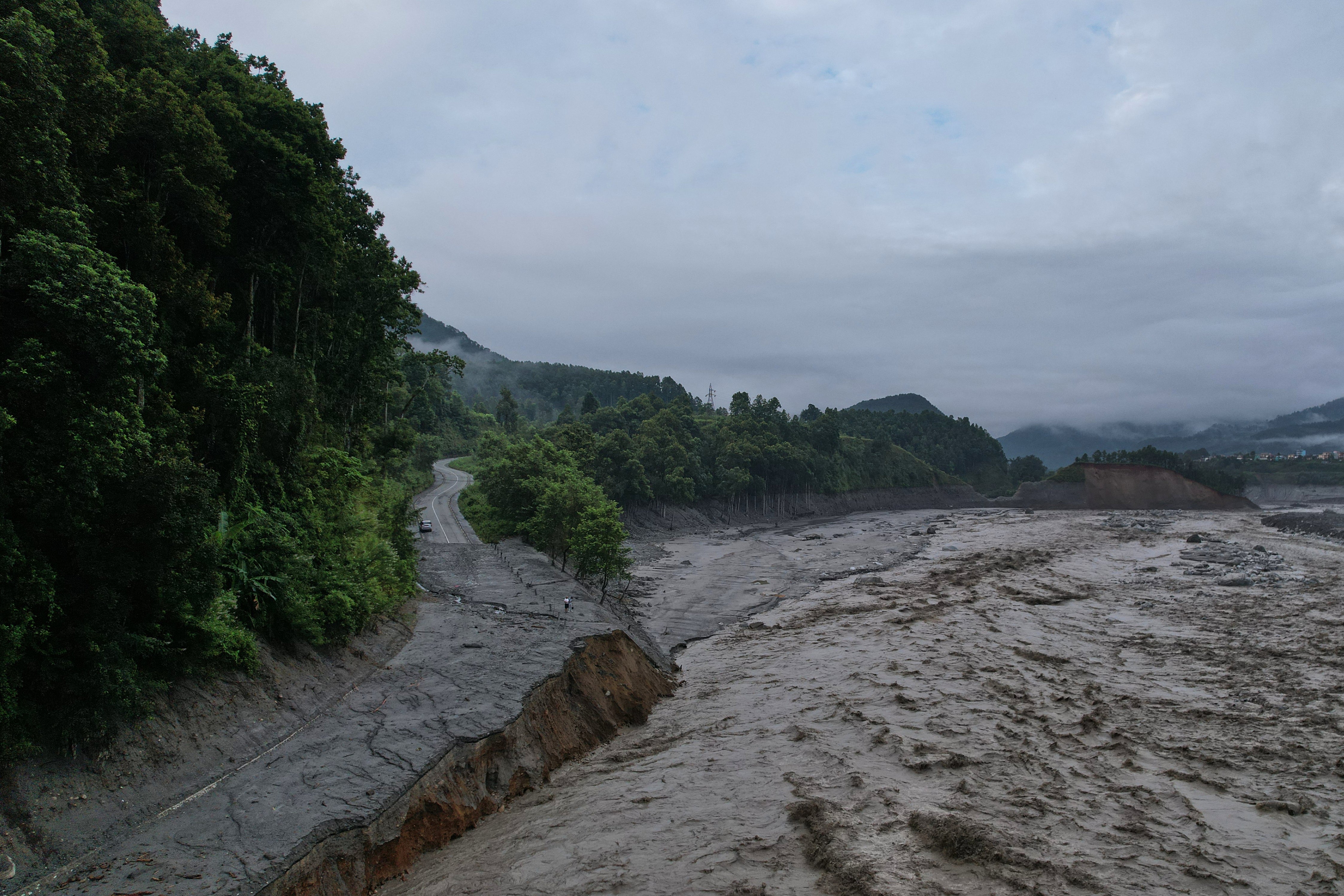 A drone view shows a major section of Pasang Lhamu highway washed away along swollen Trishuli river by recent flash floods cutting off Rasuwa district from Nuwakot area, Nepal, Monday, 31 August 2026