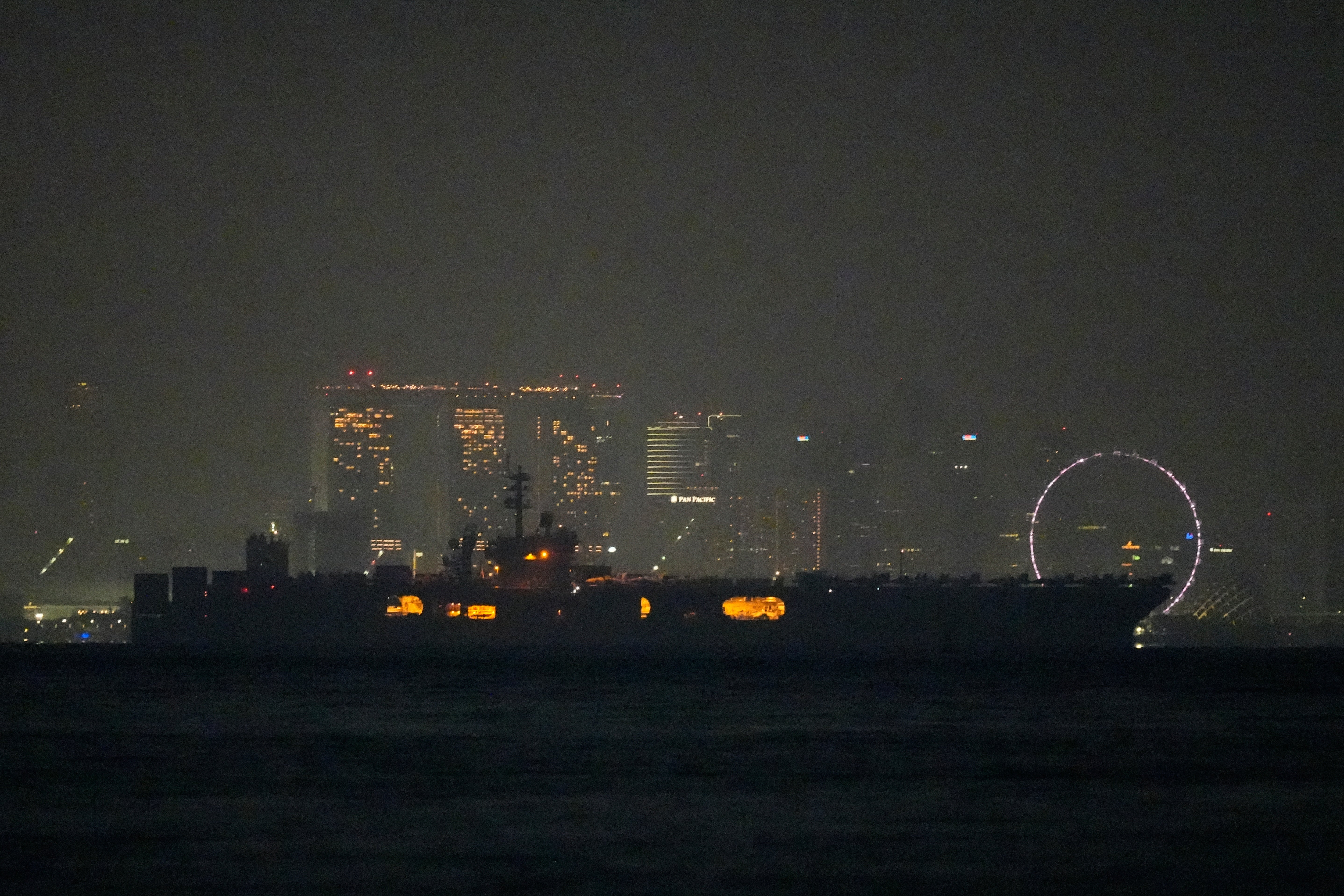 The US Navy aircraft carrier USS Abraham Lincoln sails past Singapore as seen from Batam, Indonesia, Sunday, Aug. 30, 2026. (AP Photo/Dita Alangkara)