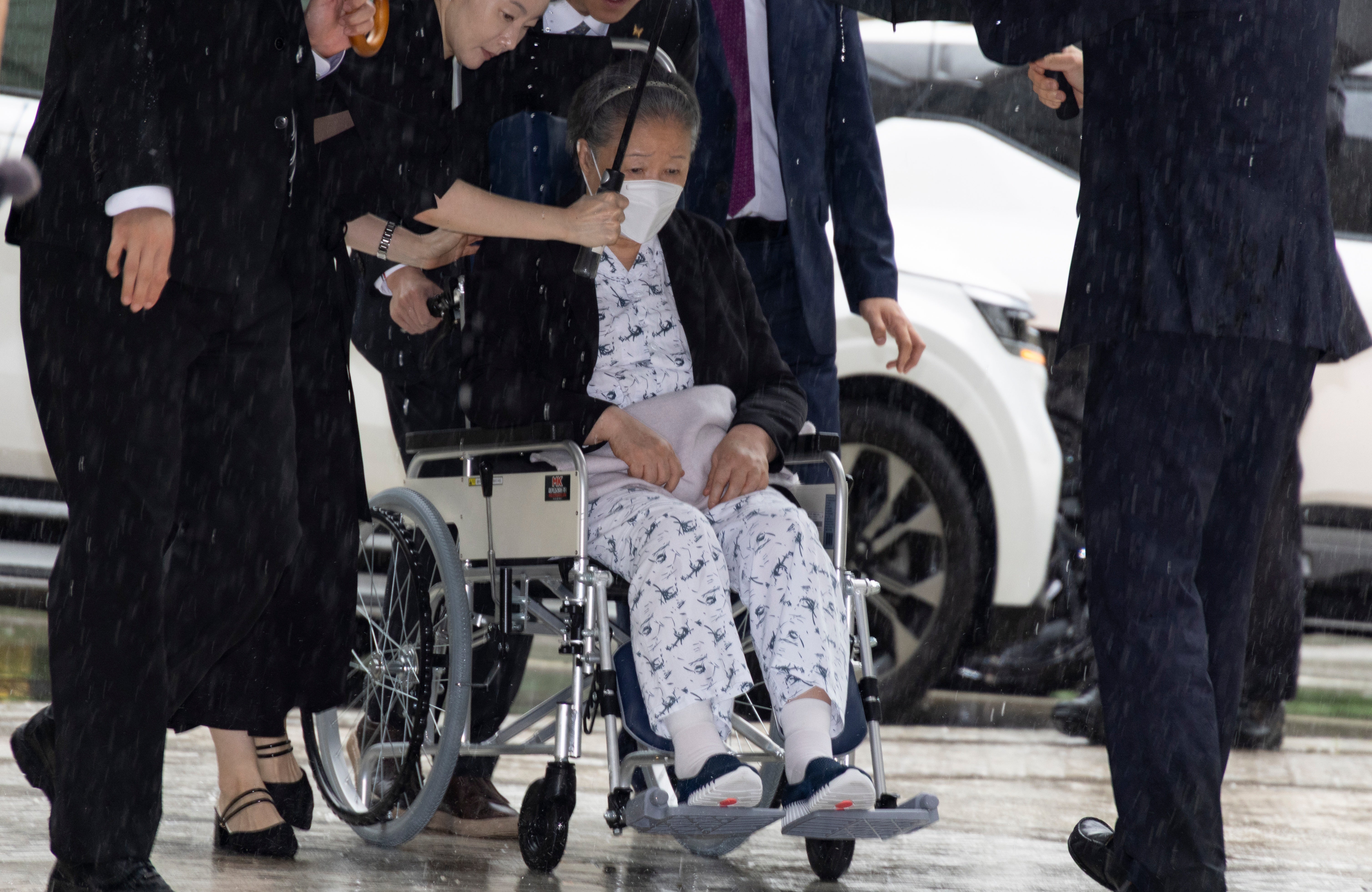 Unification Church leader Hak Ja Han, on the wheelchair, arrives for the sentencing hearing on allegations of bribery and political funding, at the Seoul Central District Court in Seoul, South Korea (AP)