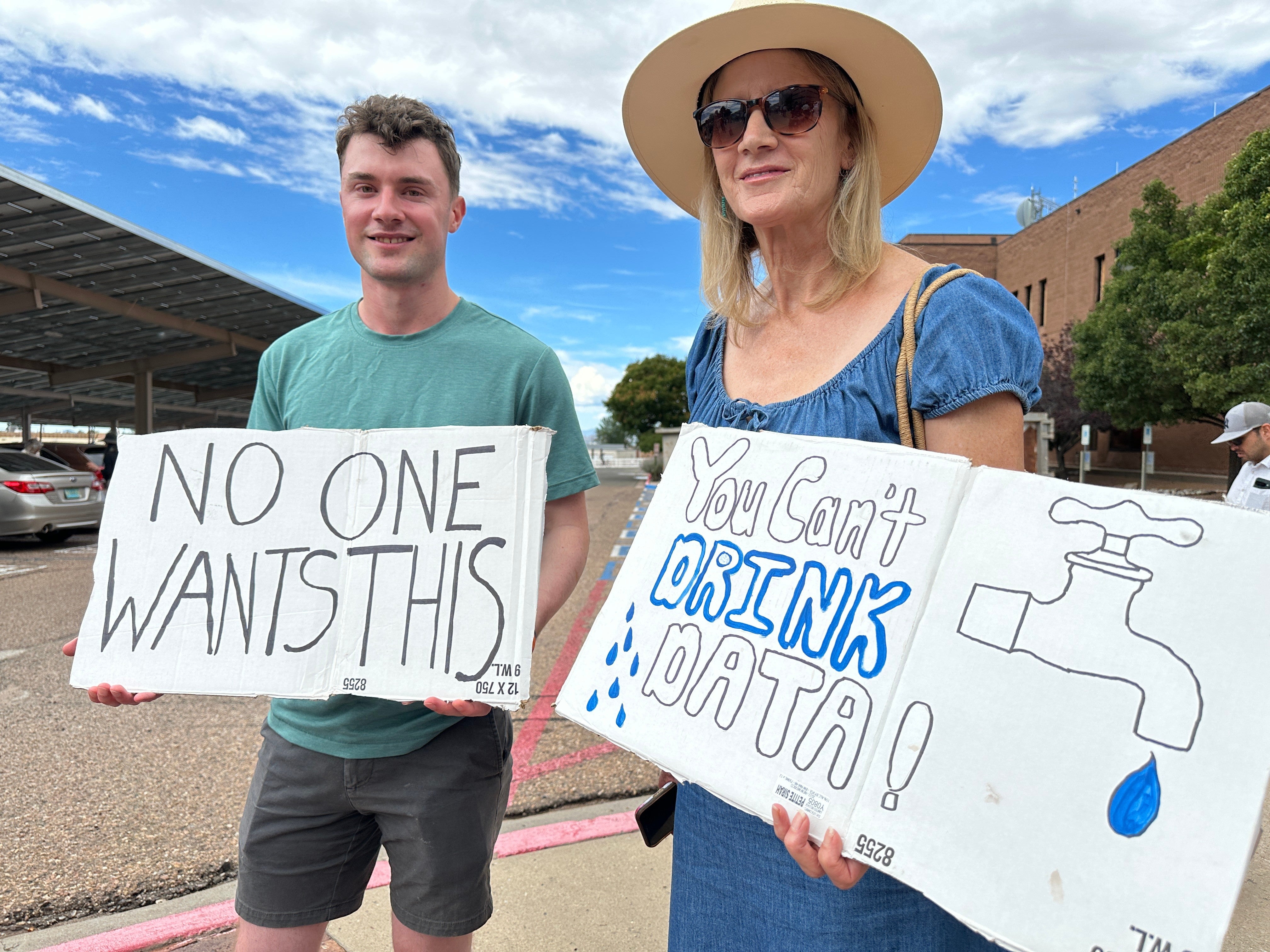 Jacob Weinreich and his mother, Sharon Metcalf, protest against a proposed data center during an August 21, 2026, demonstration in Santa Fe, New Mexico. Some cities have taken their residents trying to stop data centers to court