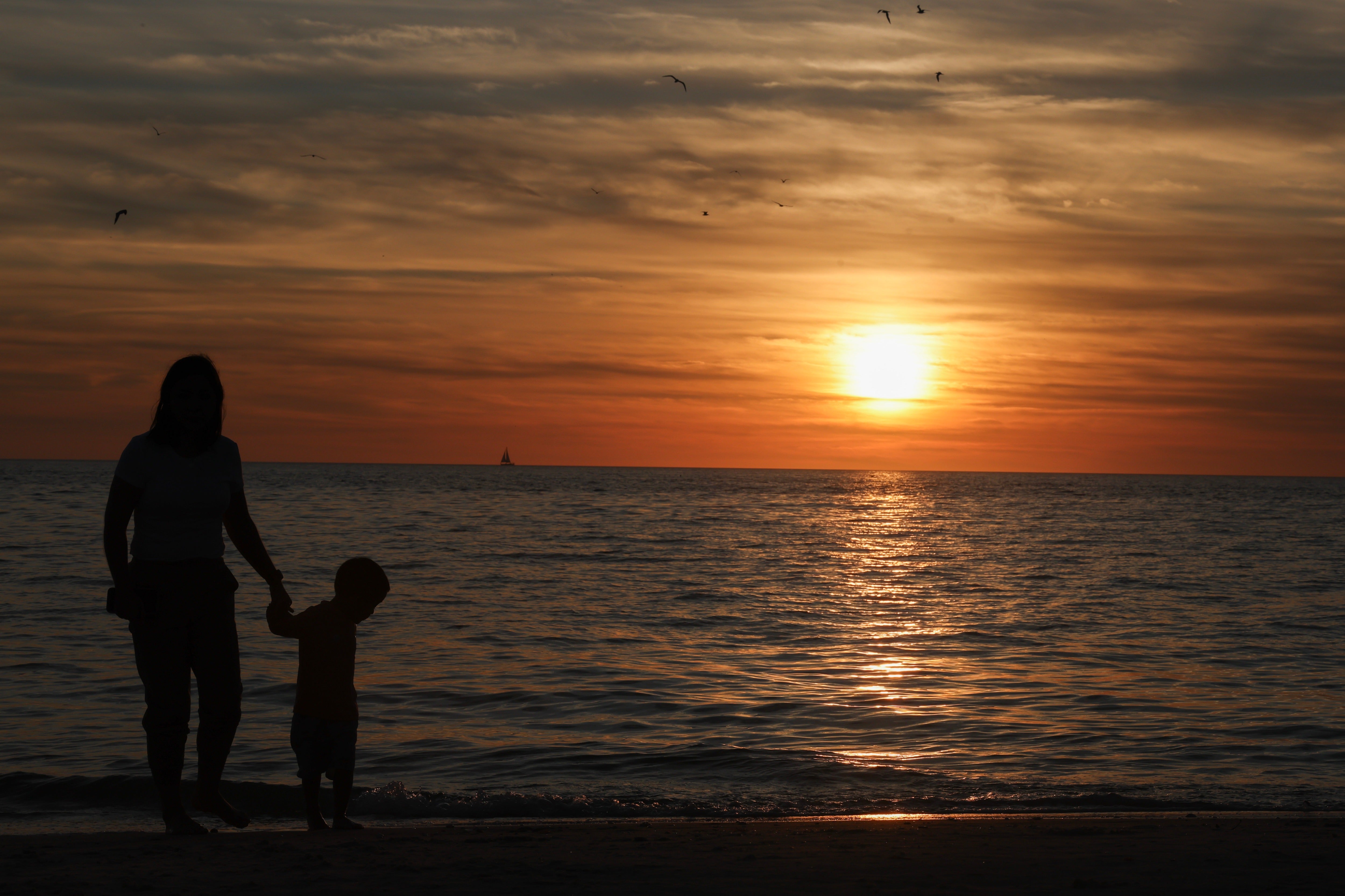 People watch the sunset over the Gulf of Mexico in Naples, Florida, in January. Americans will be losing daylight in the coming month