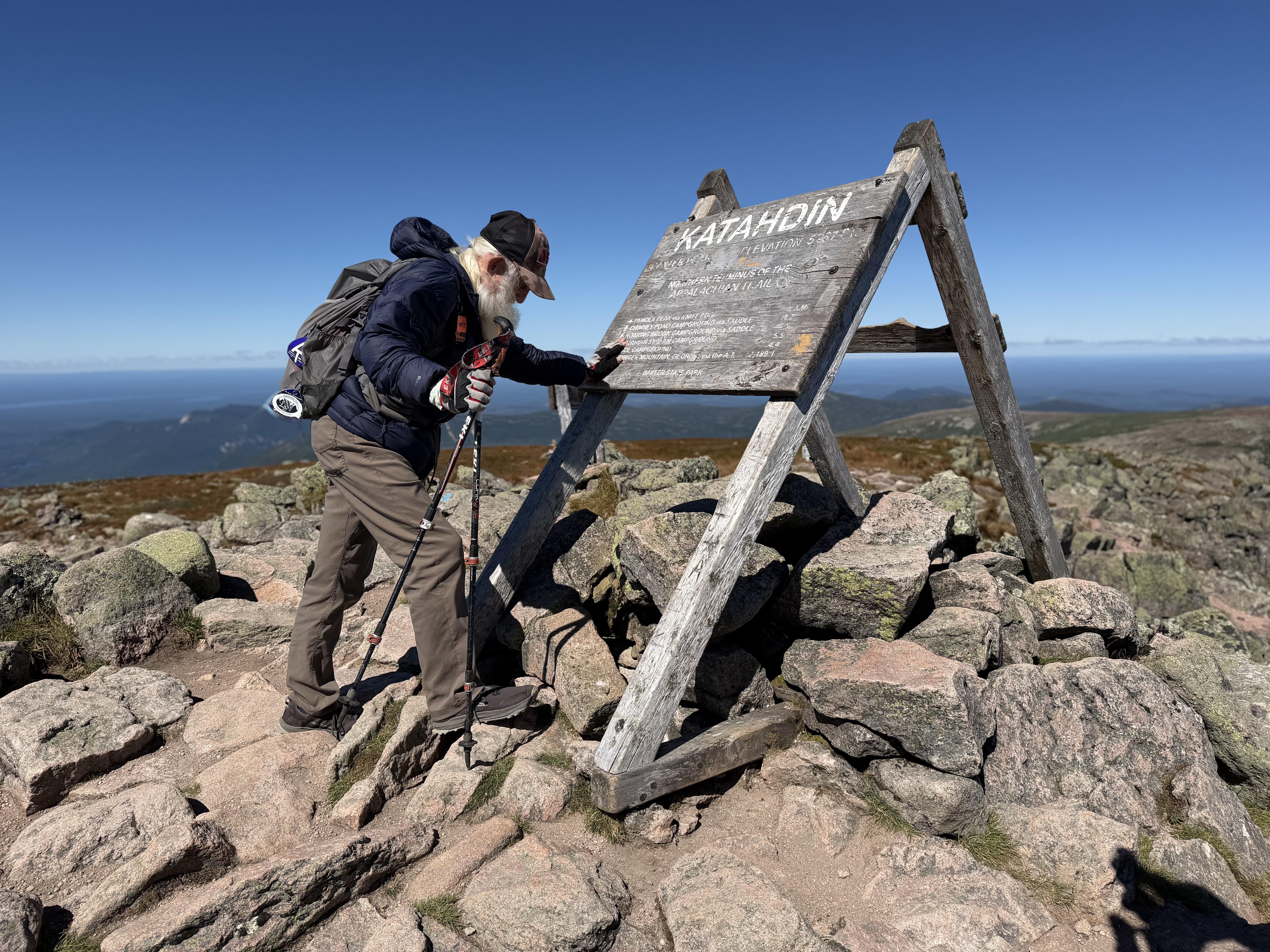 Sanders pauses for a prayer upon completing his hike of the Appalachian Trail