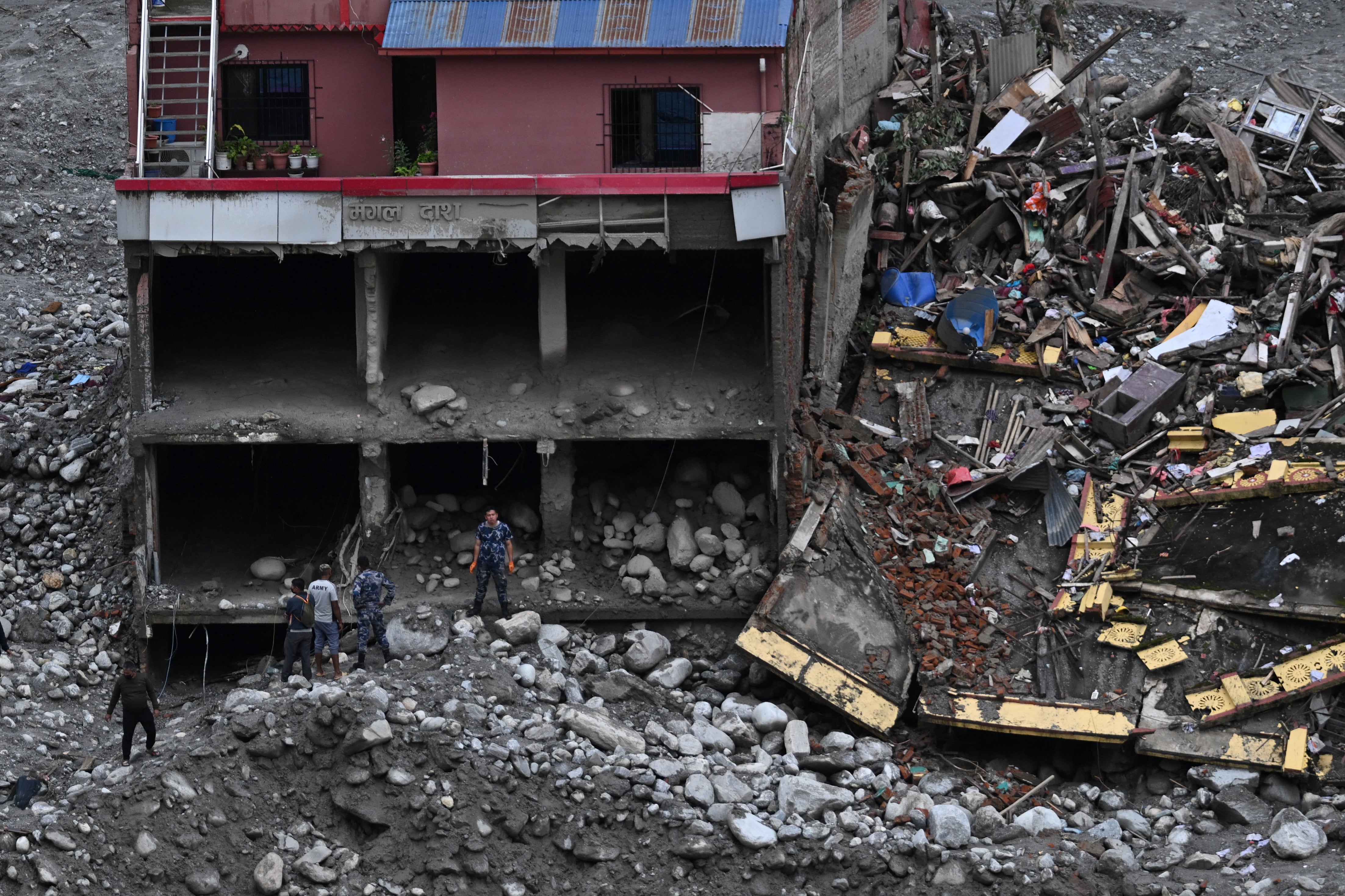 Nepal's army personal take part in search operations in the aftermath of flash floods in Nepal's Nuwakot district