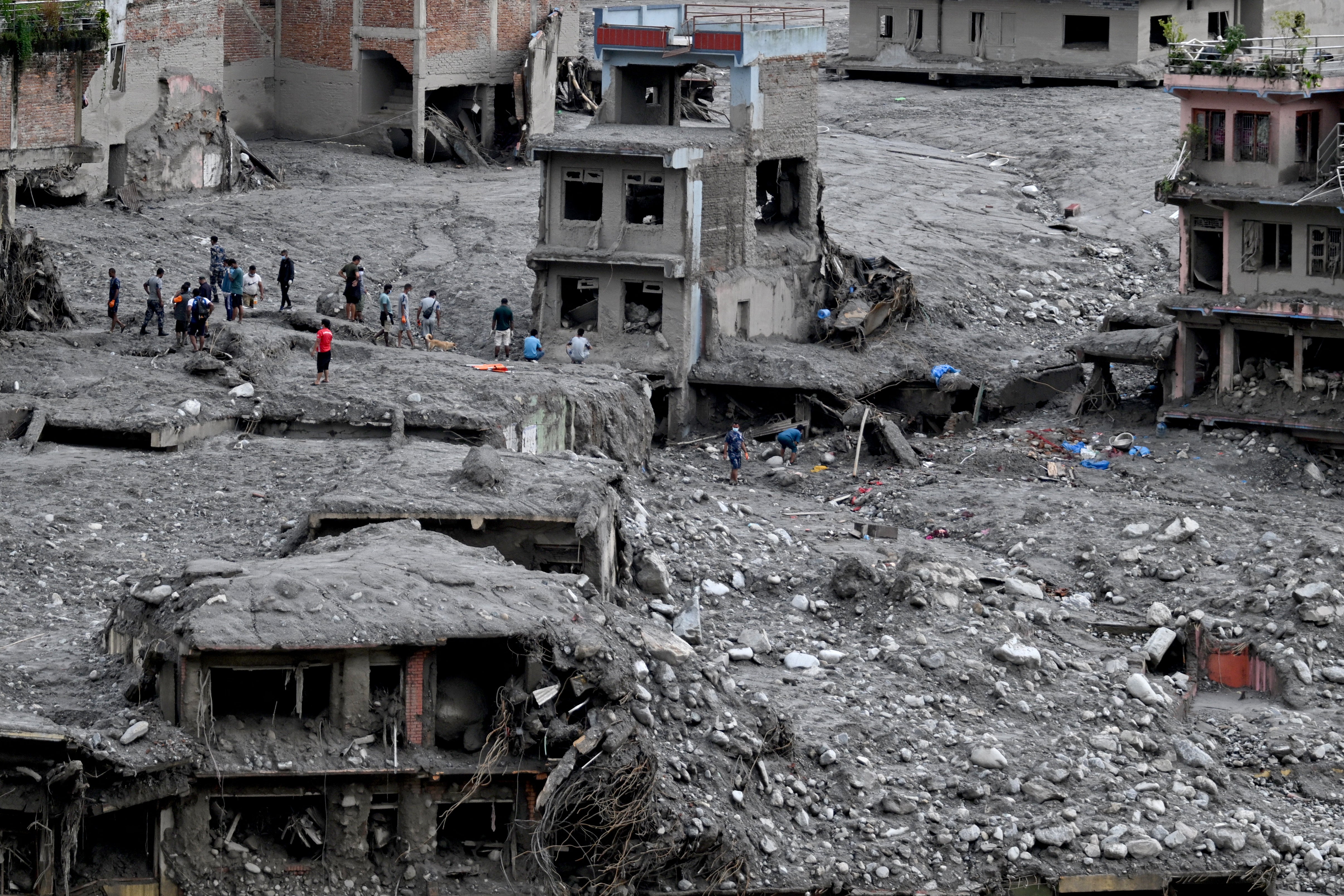 People scout for usable materials from debris after flash floods at Trishuli Center in Nepal's Nuwakot district on September 1, 2026