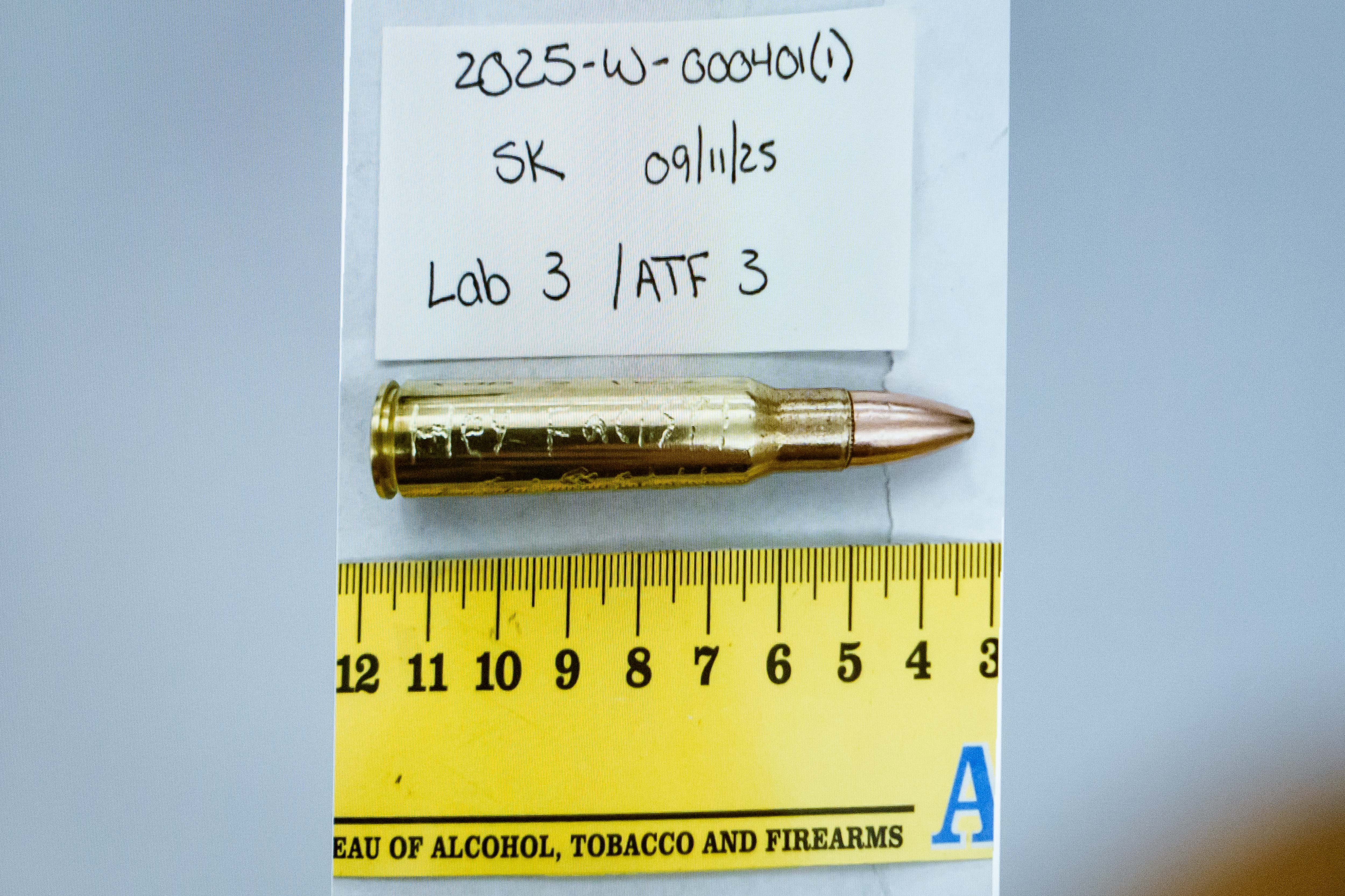 An image of a bullet casing engraved with the words, 