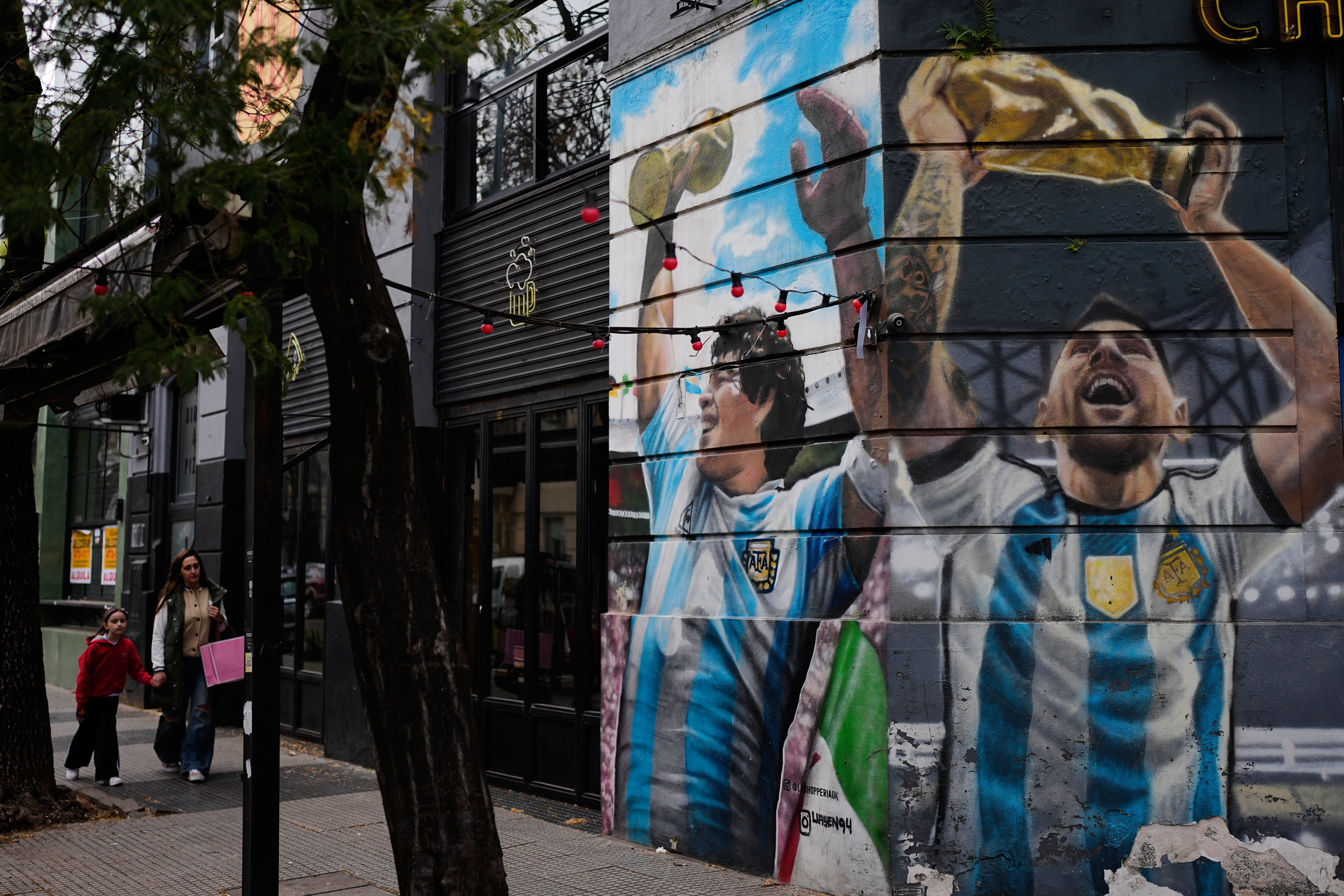 A mural of Argentina greats Diego Maradona and Lionel Messi