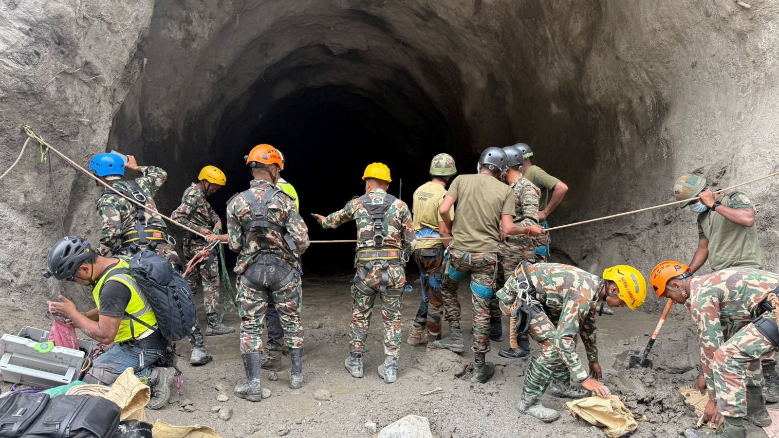 Nepal army soldiers work during a search and rescue operation outside a tunnel near the Hydropower Project sites, following deadly flash floods and mudslides, in Rasuwa district, Nepal