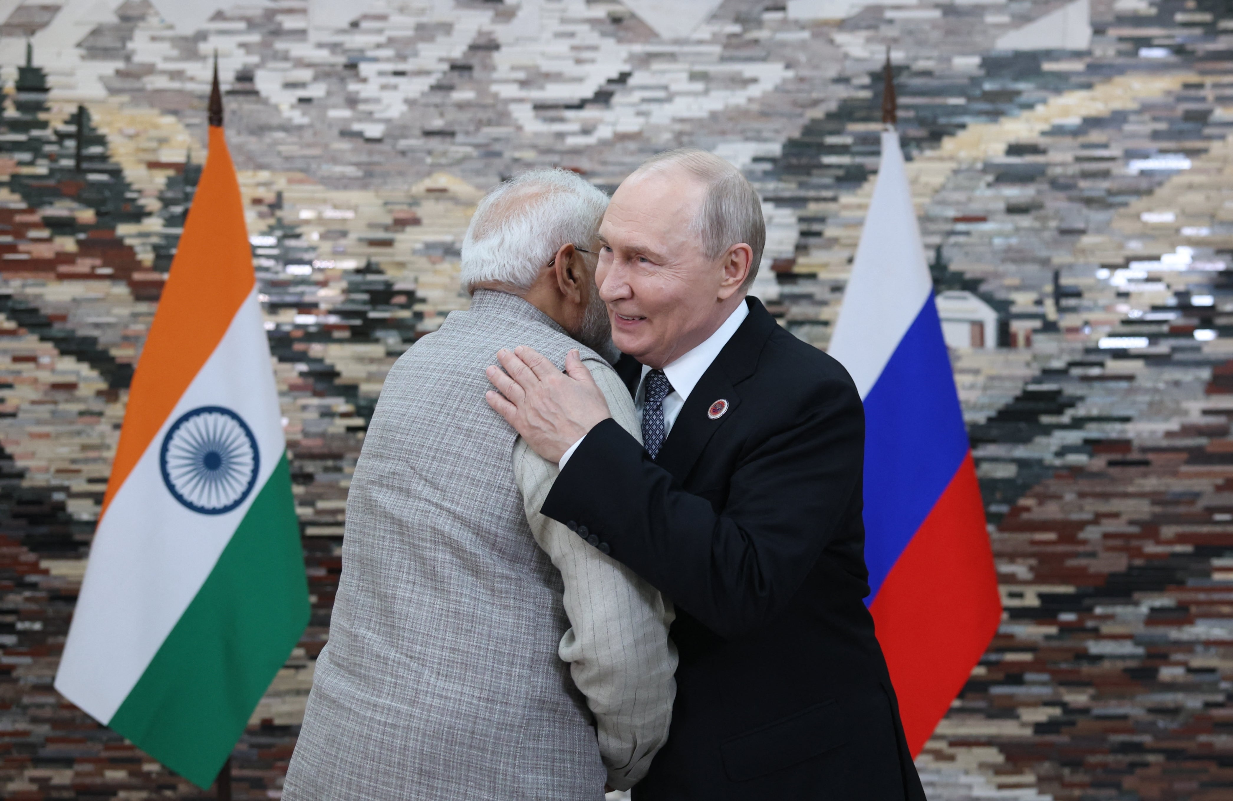 Vladimir Putin and Narendra Modi greet each other during a meeting on the sidelines of the Shanghai Cooperation Organisation