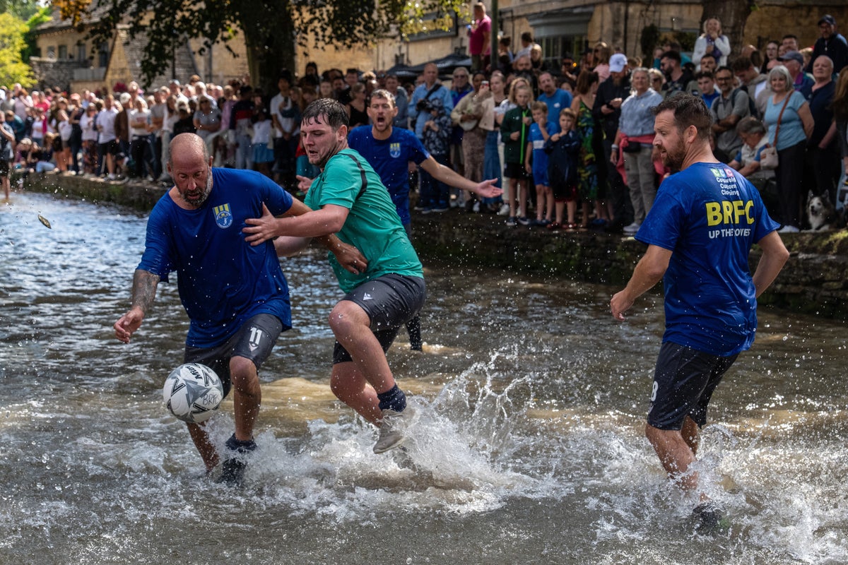 Hundreds flock to the Cotswolds to watch bizarre football match in river