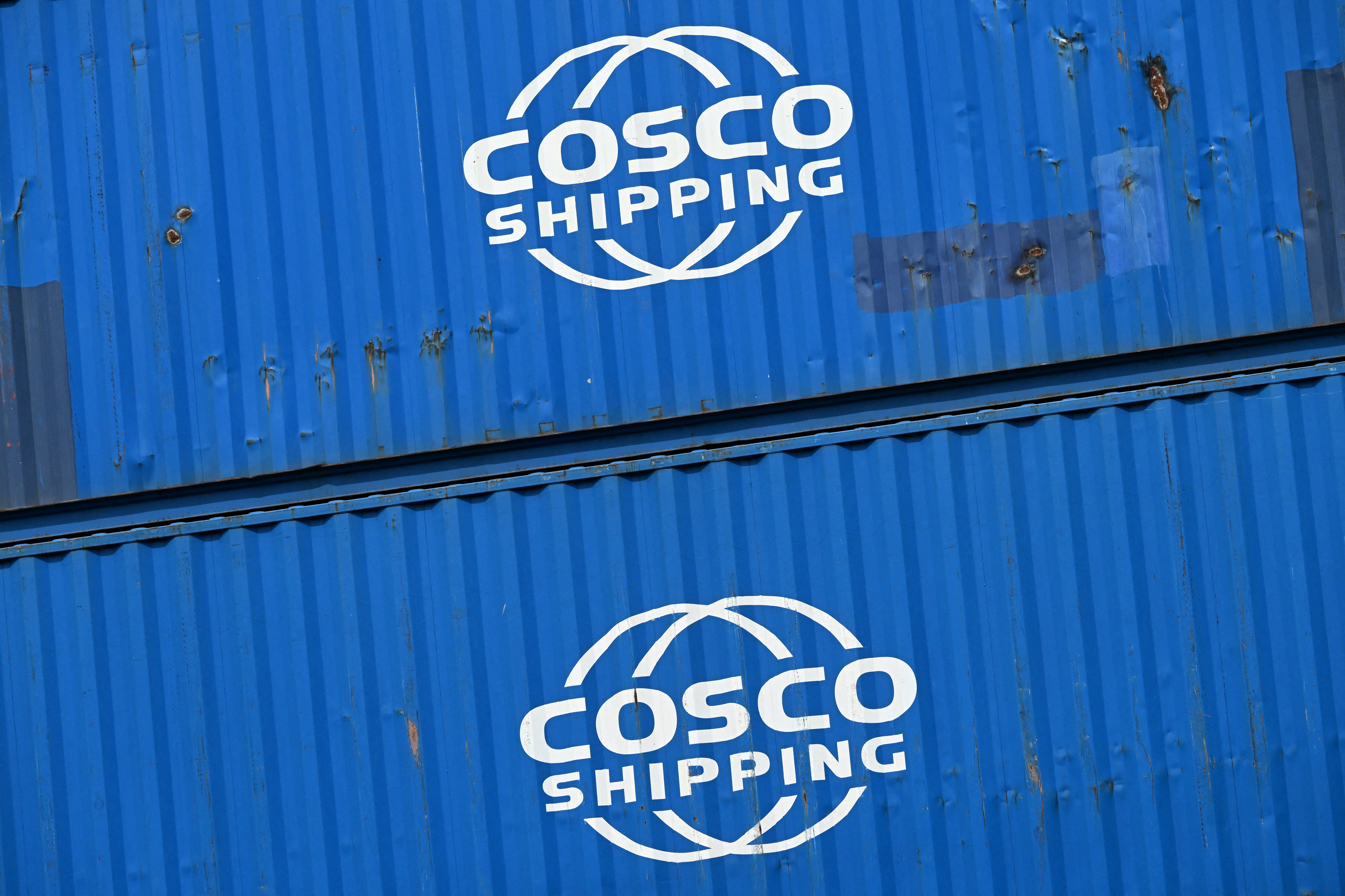 Containers of the Cosco shipping company are stacked at a transshipment station in Frankfurt