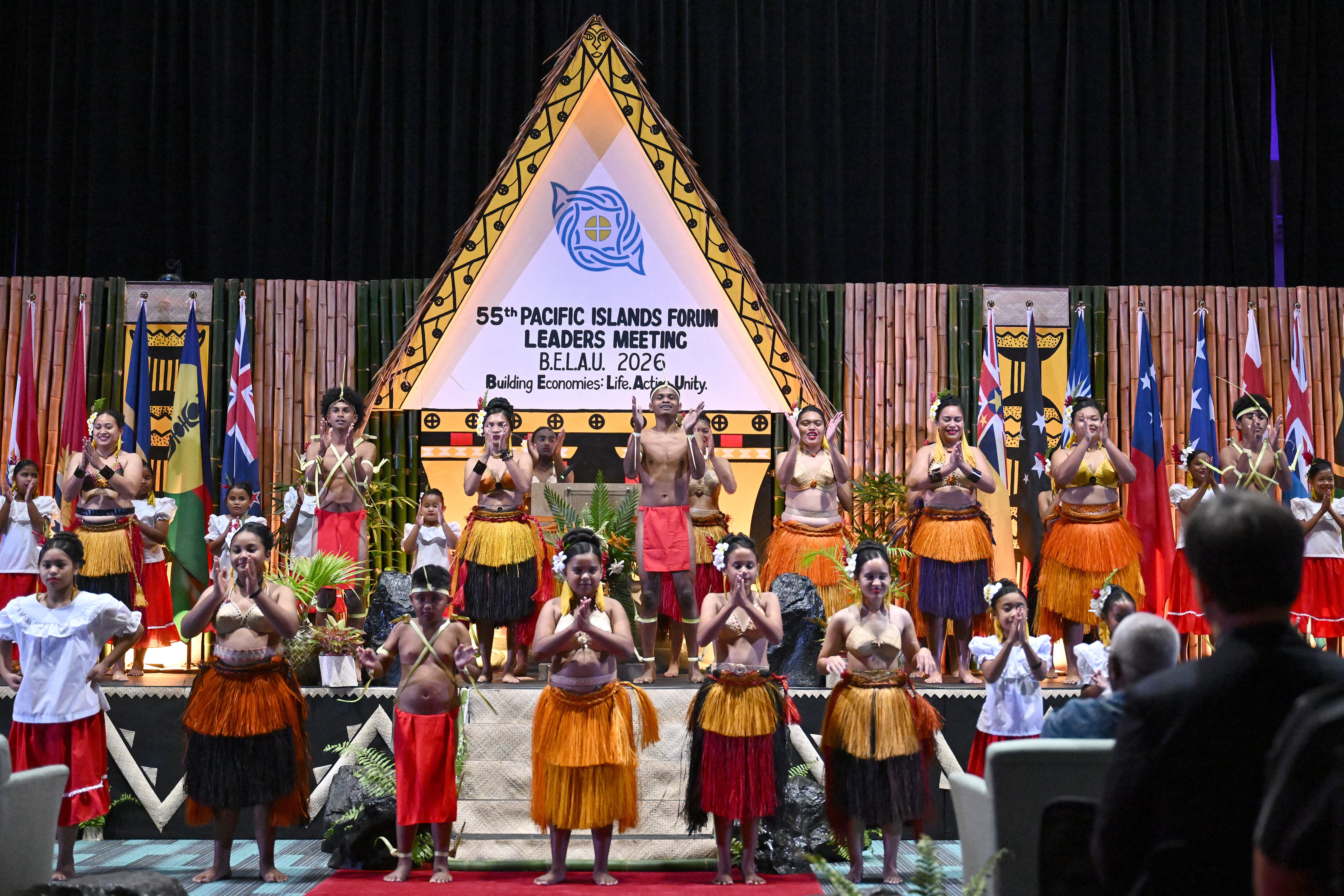 Traditionally dressed artists perform during the opening ceremony of the 55th Pacific Islands Forum Leaders Meeting in Koror