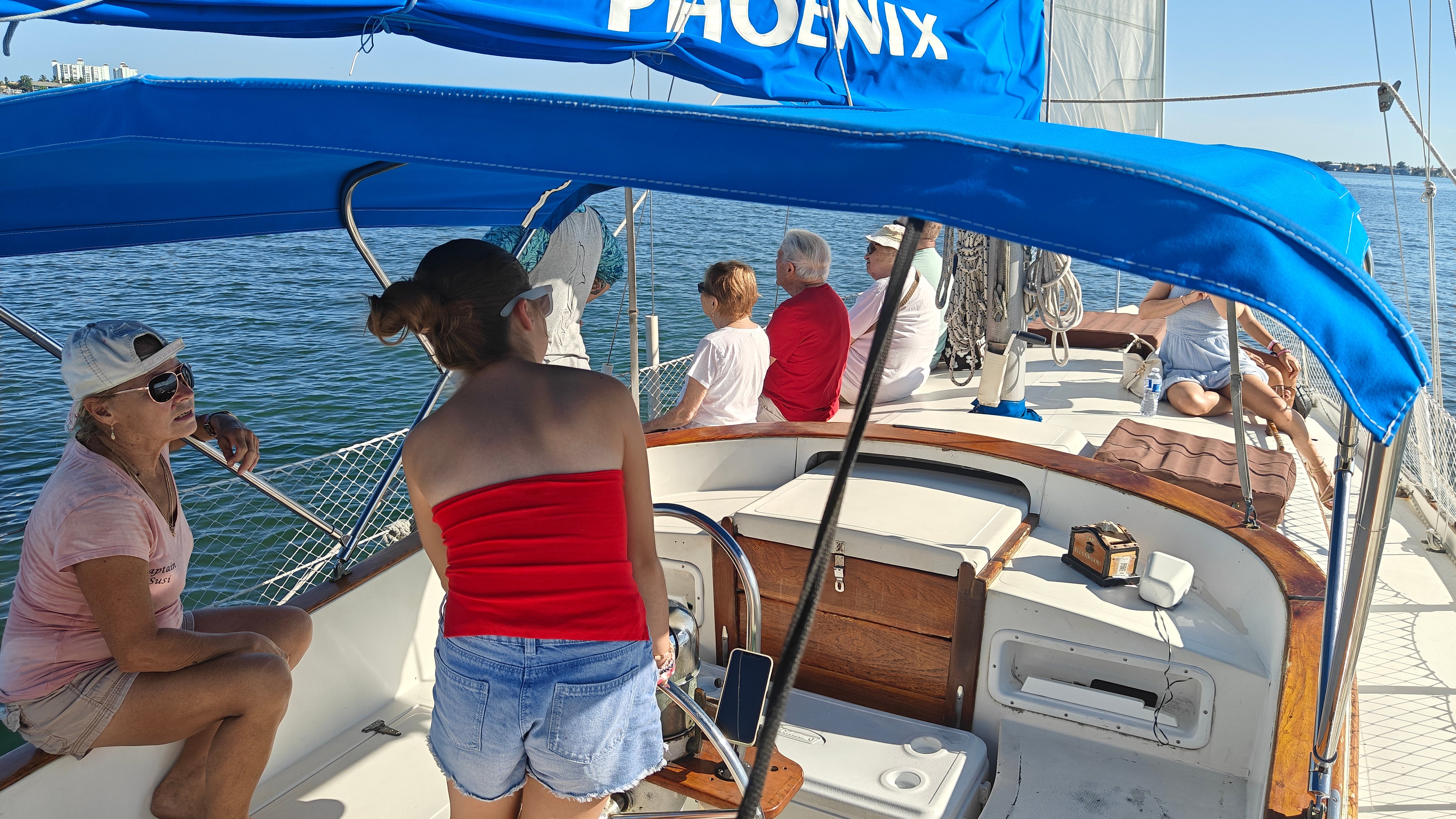 Amelie takes the helm of our boat on the search for dolphins under the eye of captain Susi