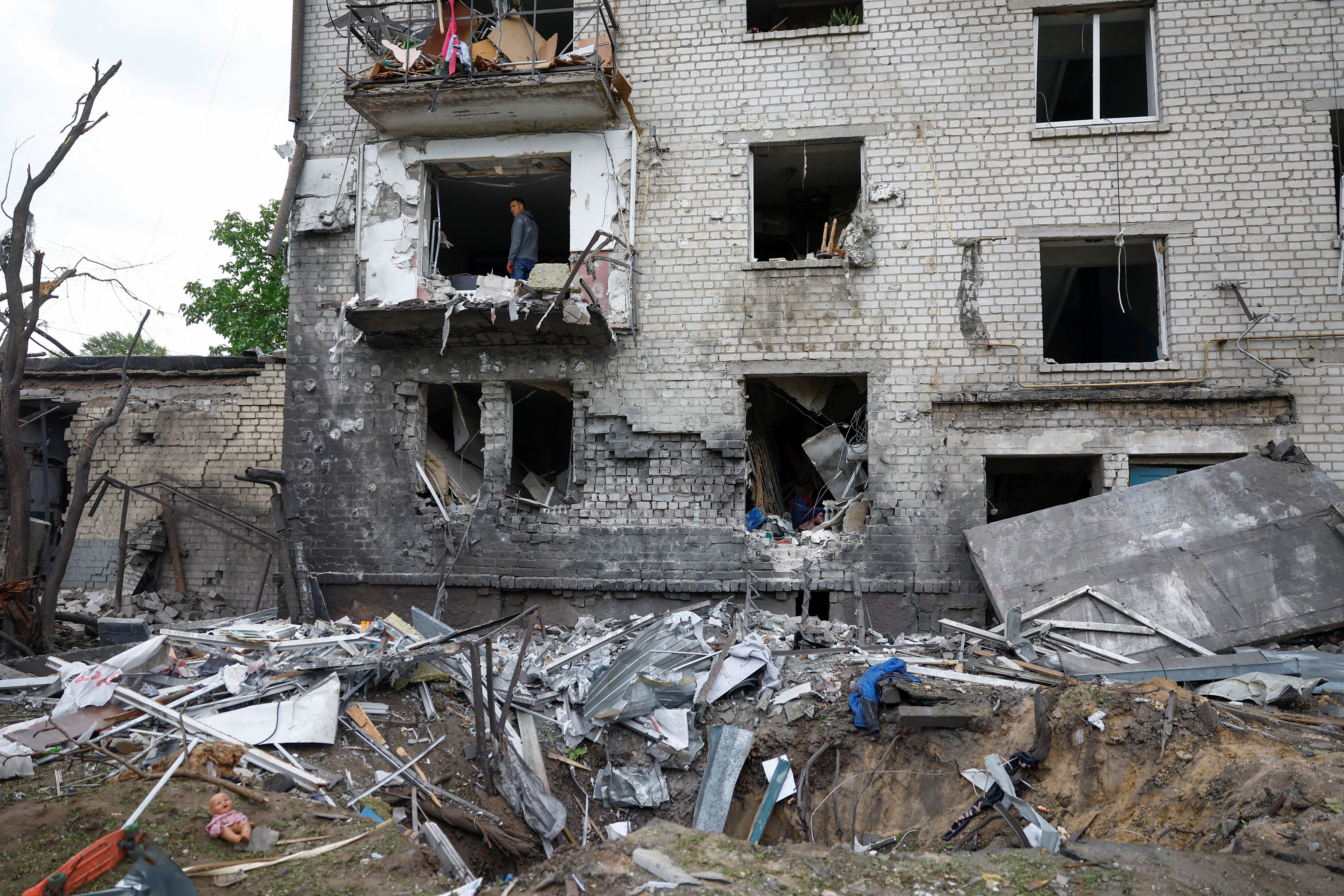 A man stands inside of an apartment damaged by a Russian missile strike in the town of Boryspil, amid Russia's attack on Ukraine, in Kyiv region (Reuters)