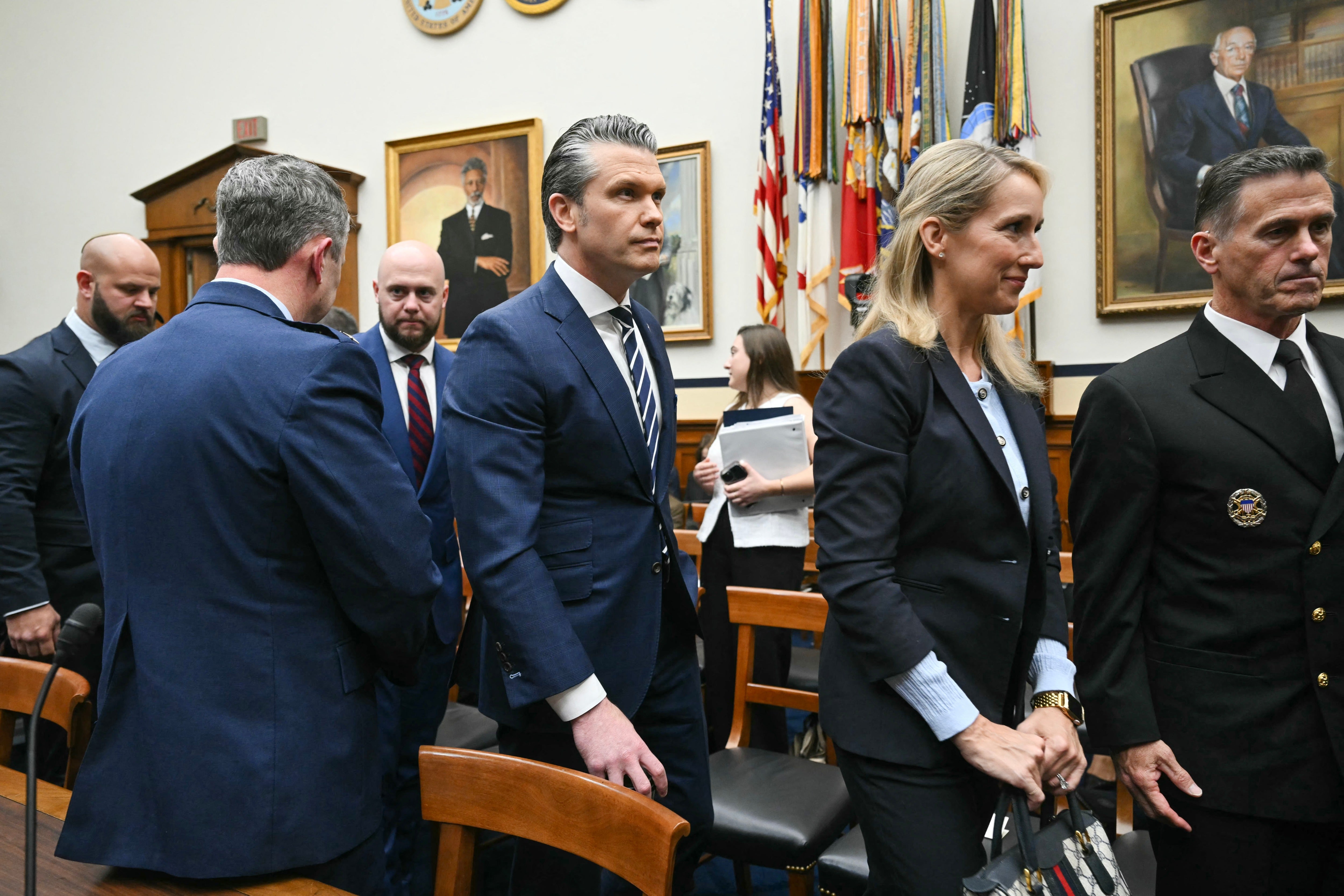 Secretary of Defense Pete Hegseth (C) and his wife Jennifer Hegseth leave for recess during a US House Armed Services Committee hearing titled 
