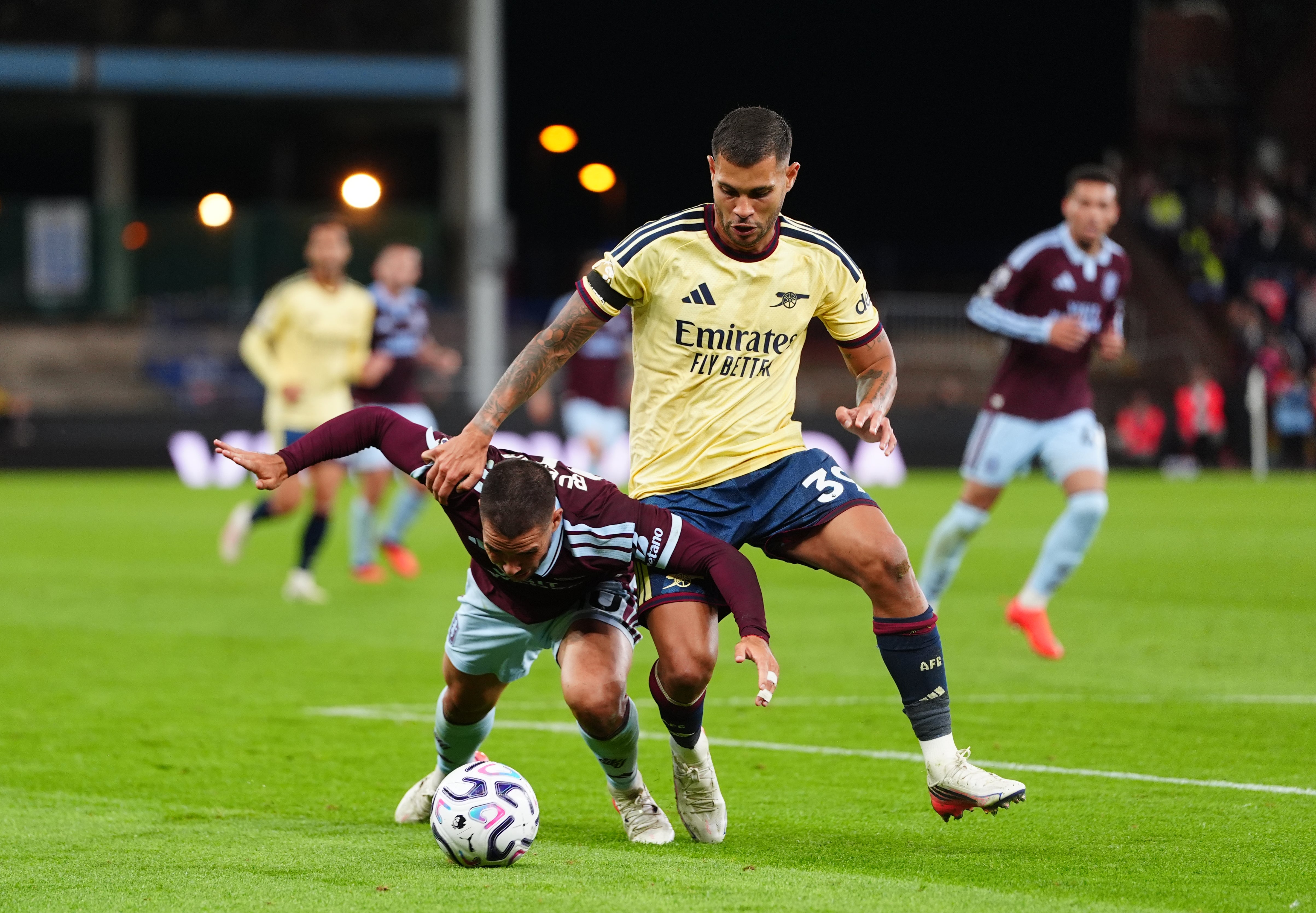 Aston Villa's Emi Buendia and Arsenal's Bruno Guimaraes battle for the ball
