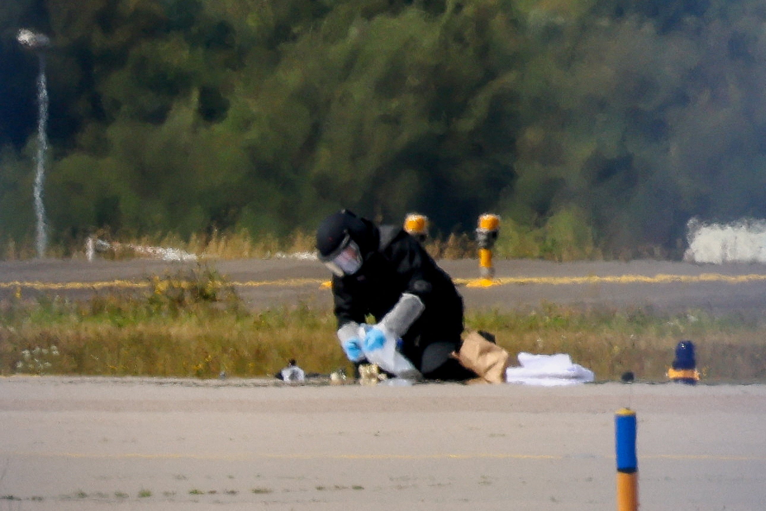 A police officer examining explosives found at Leipzig Airport