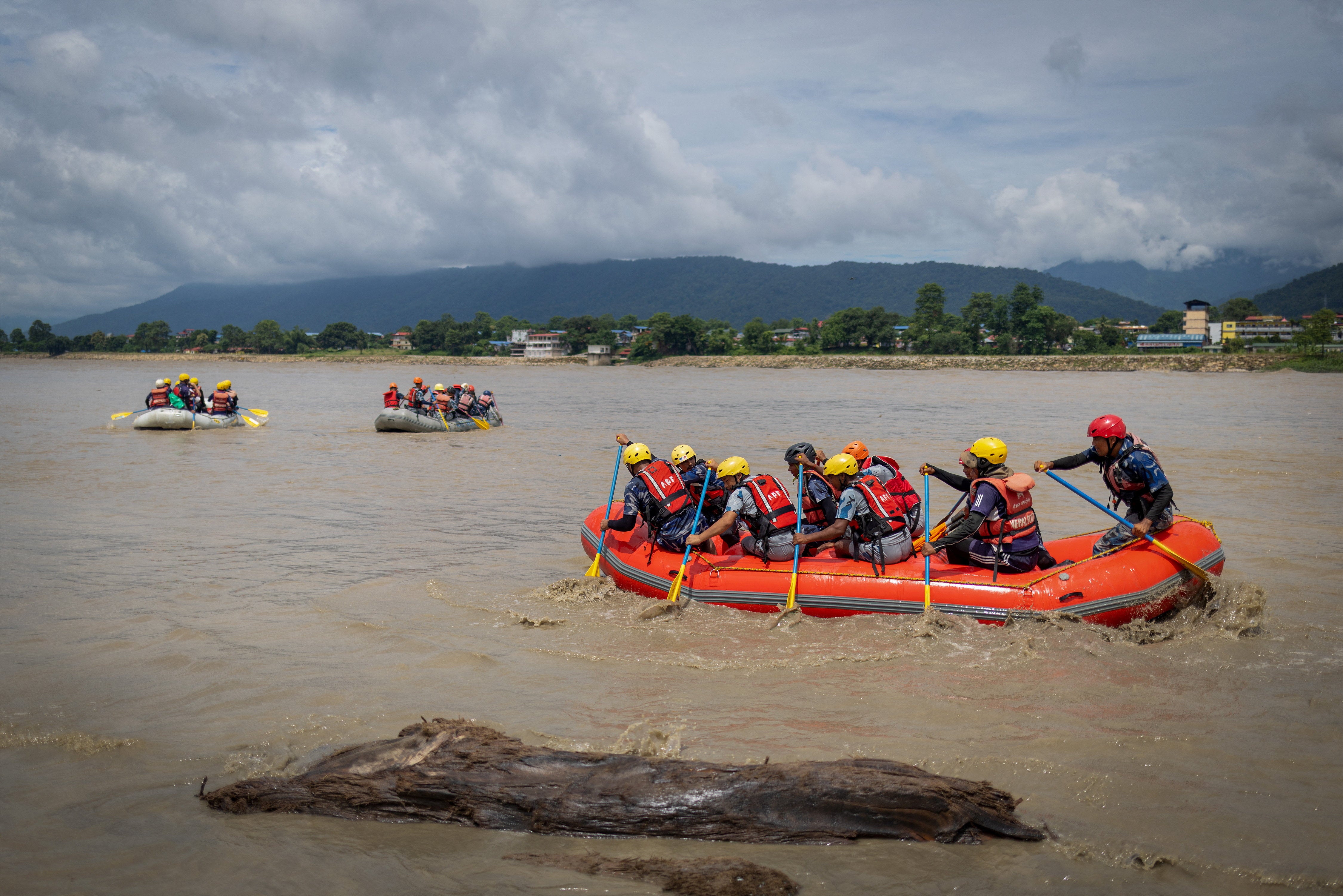 Members of the Armed Police Force (APF) conduct a search operation in the Narayani River (Reuters)