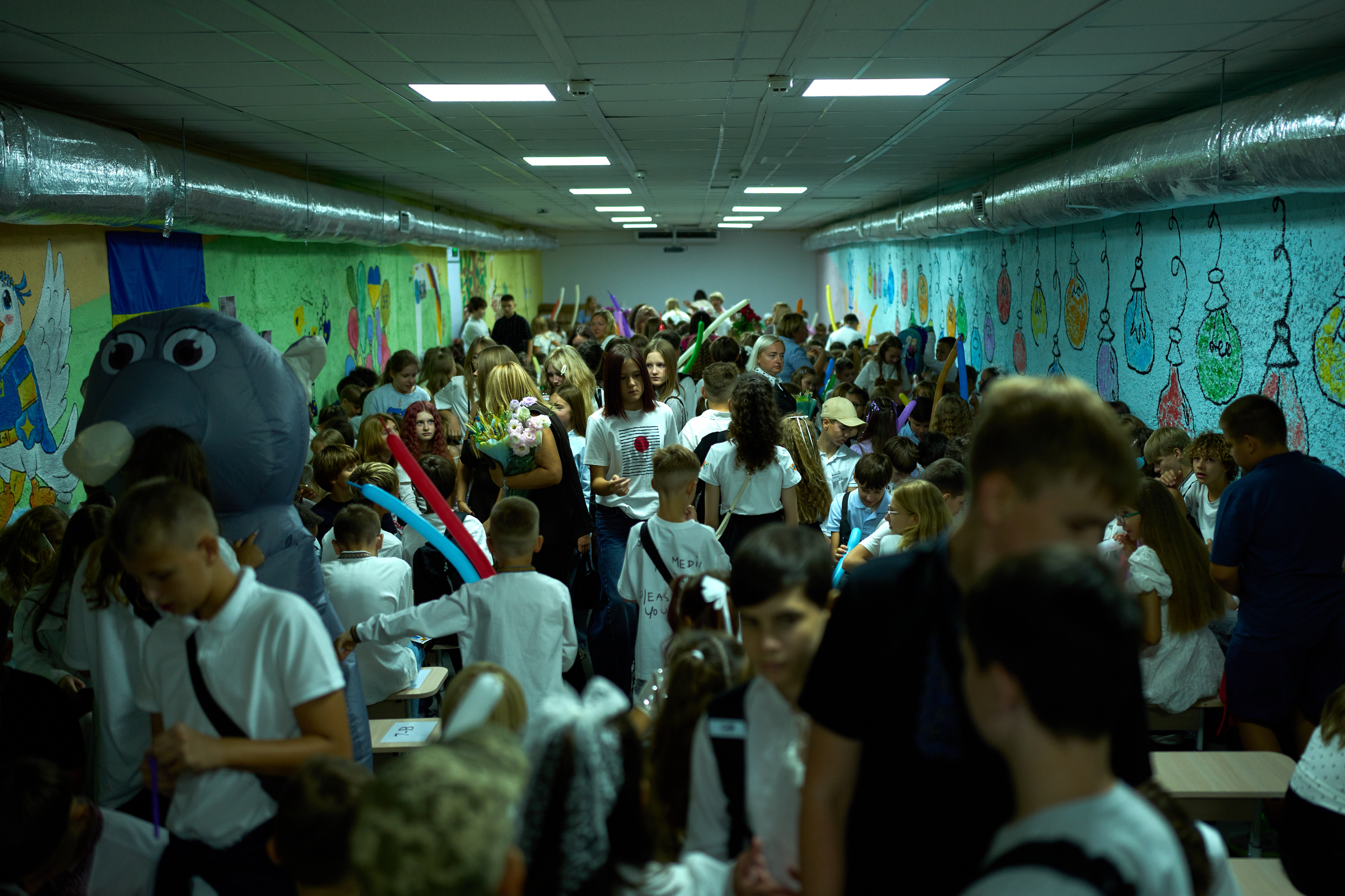 Children, parents and teachers stay in an underground shelter during an air raid alarm during the traditional back to school celebrations in Kyiv, Tuesday, Sept. 1, 2026