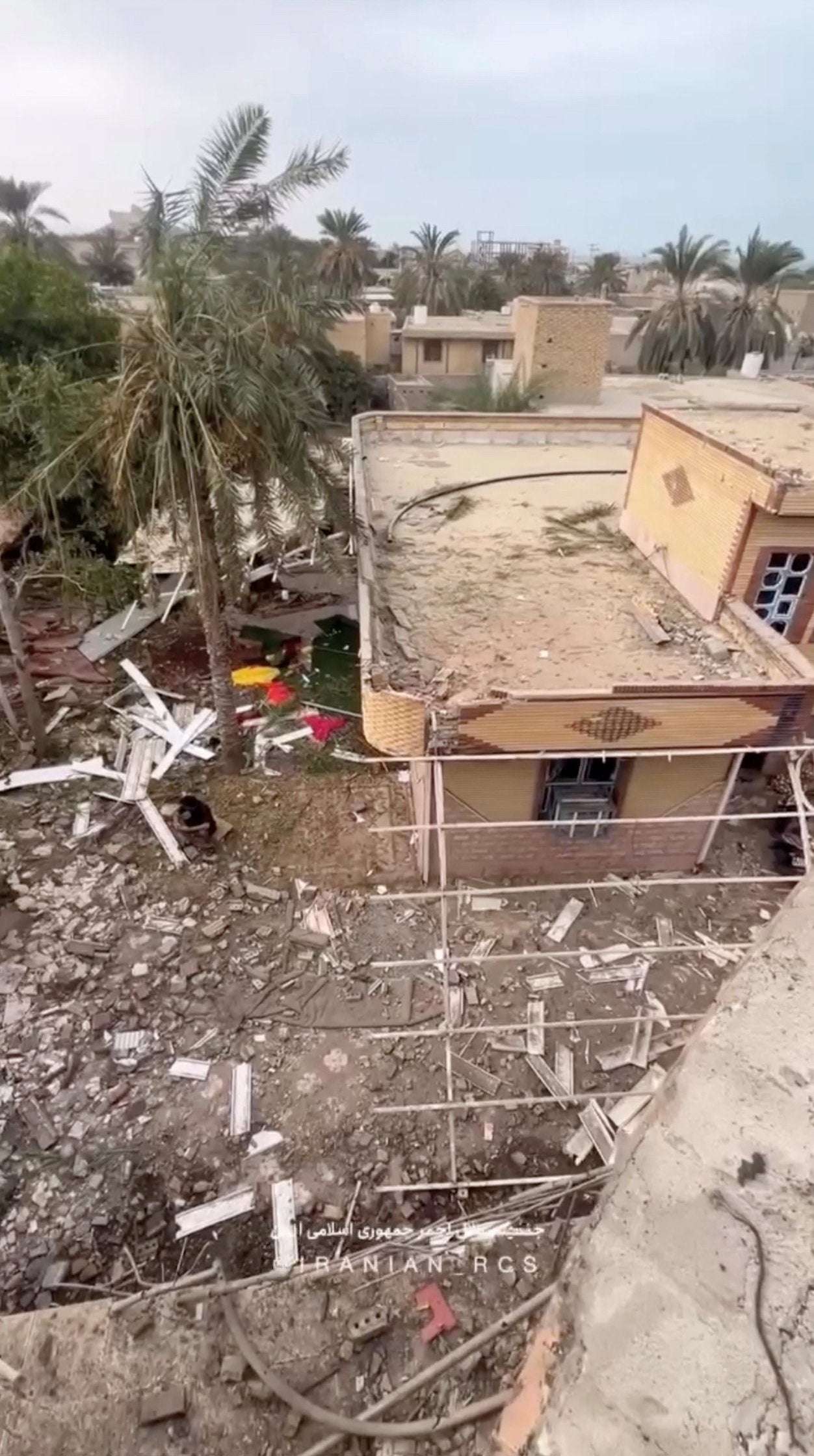 Rubble lies around damaged houses following a reported attack near a wedding gathering in Kuhistik, Sirik