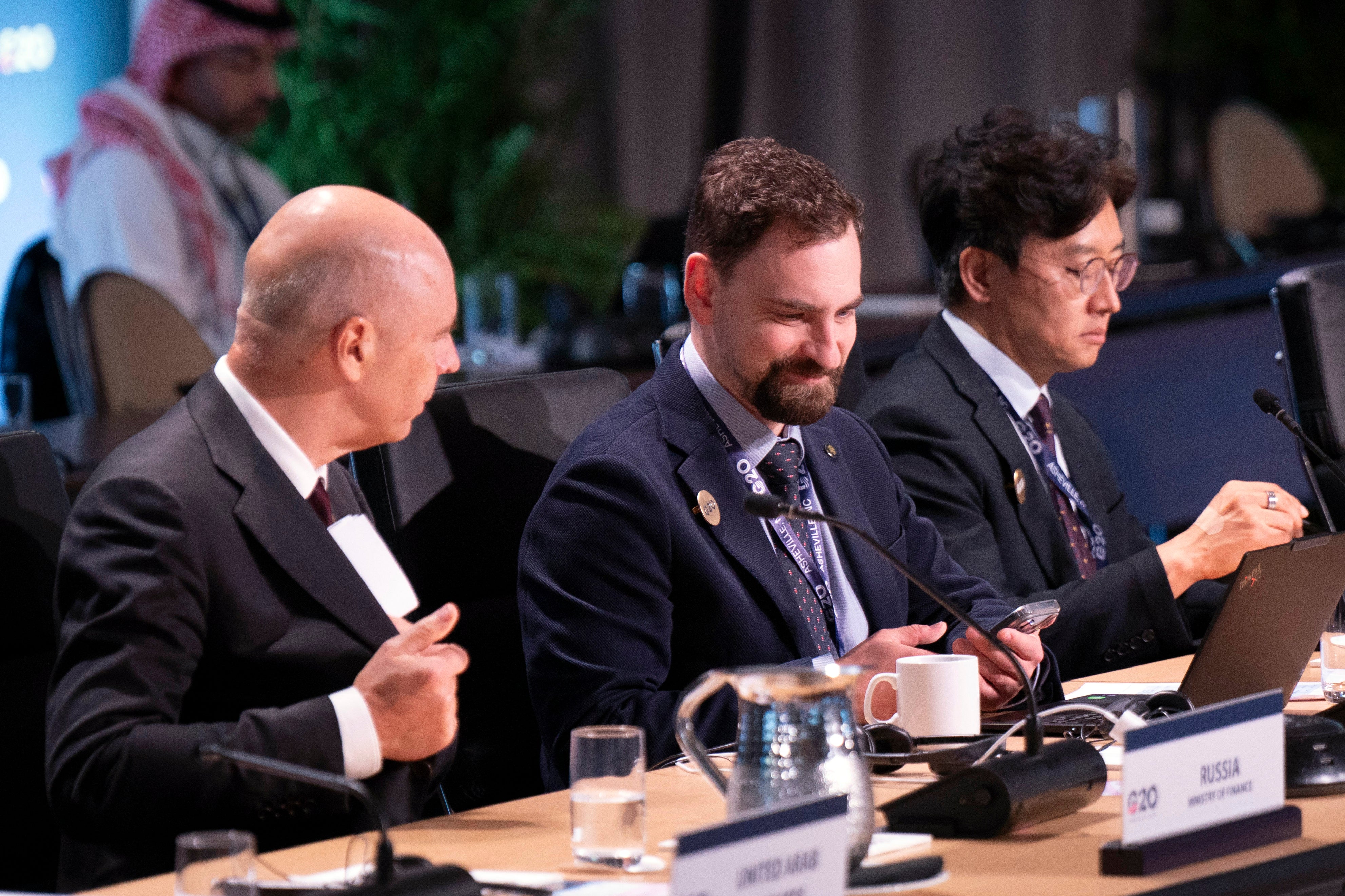 Russia's Finance Minister Anton Siluanov (L) and Russia's Head of International Cooperation Financial Stability Department Kirill Markov (C) attend the G20 Finance Ministers and Central Bank Governors' meeting