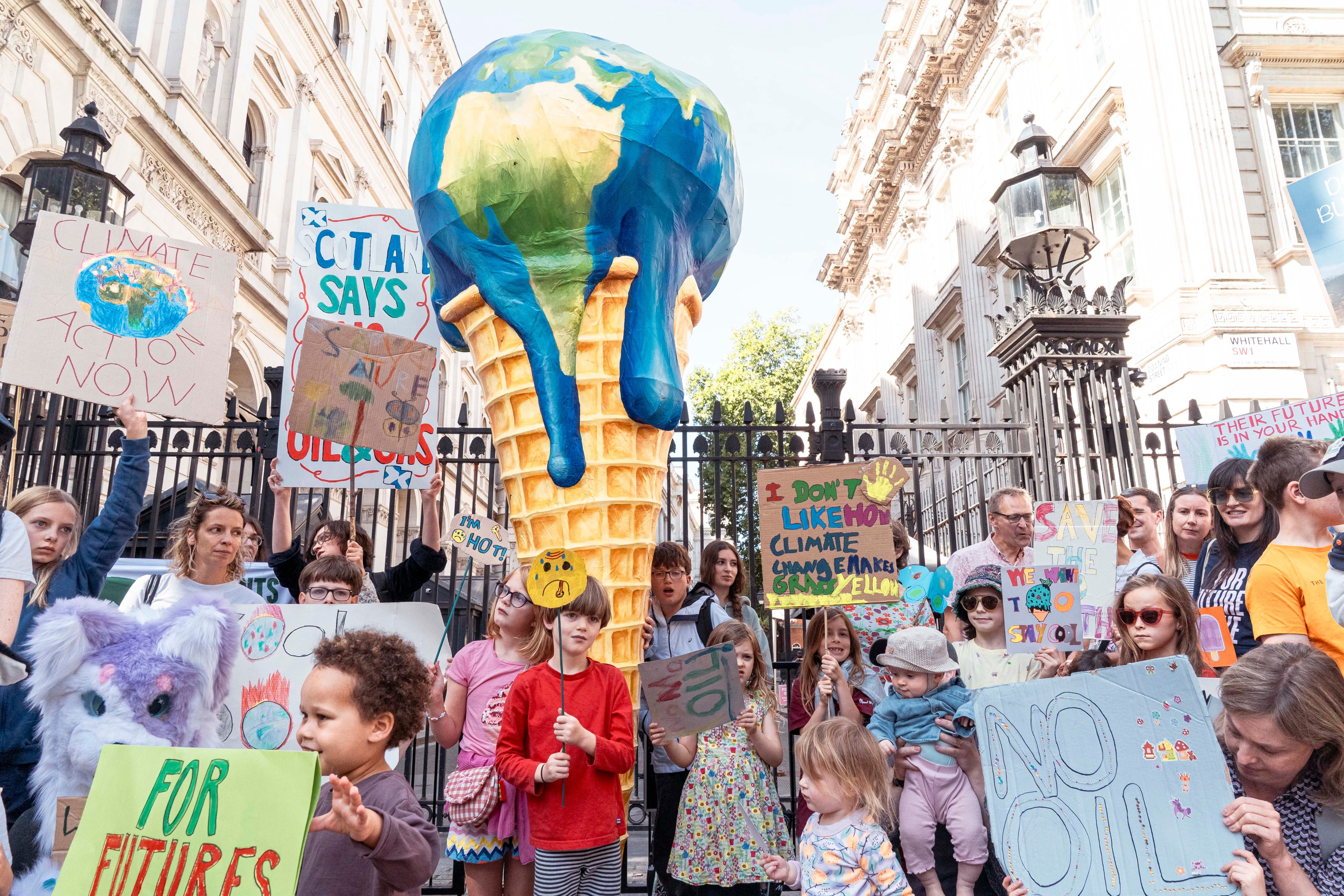 A giant melting-planet ice cream is displayed outside 10 Downing Street as Mothers Rise Up calls for urgent heat adaptation, clean energy and an end to new North Sea oil and gas