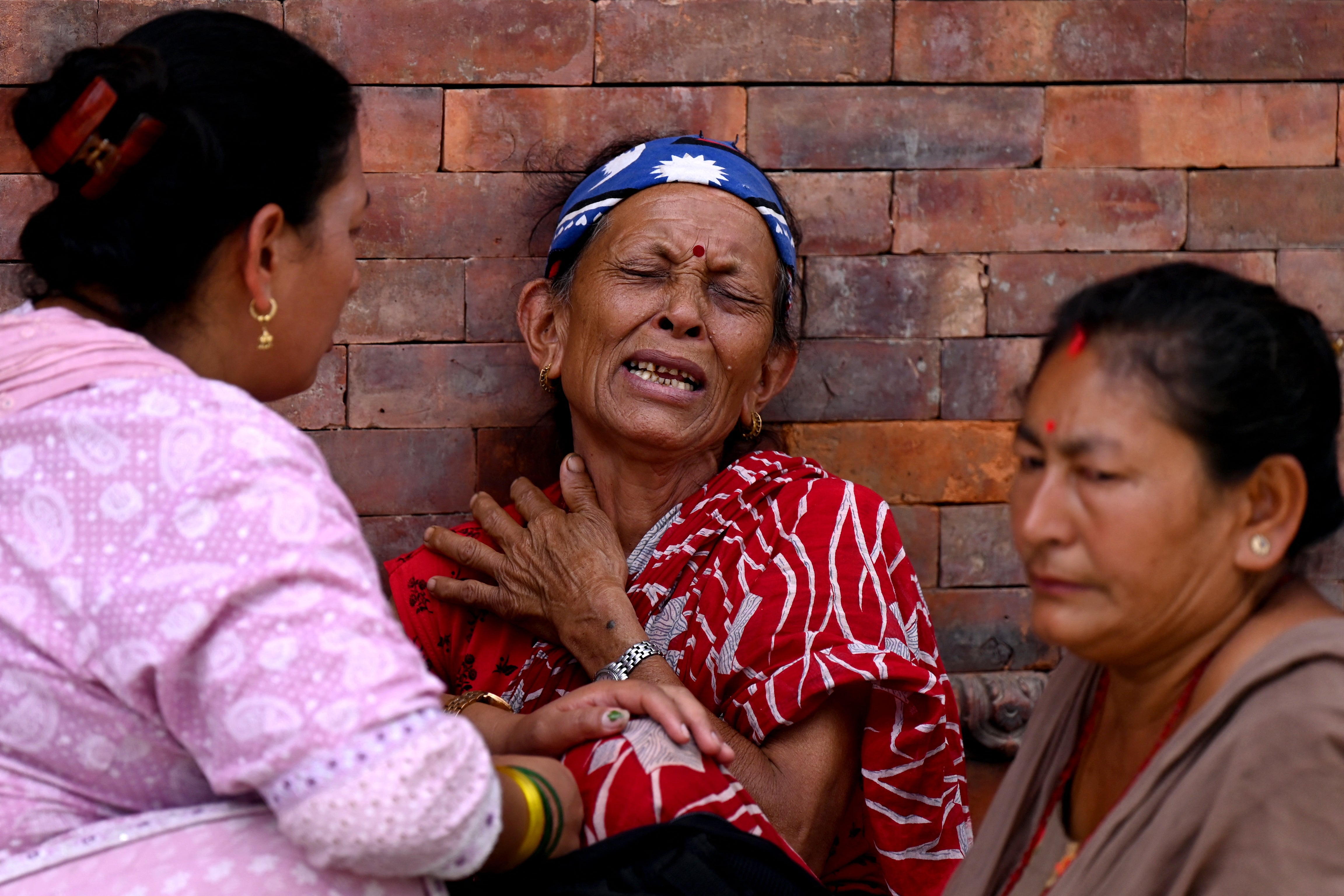 Relatives mourn during symbolic funerals held for flood victims still reported missing as they cremate Kush grass effigies in accordance with Nepali Hindu rites at the Pashupatinath temple in Kathmandu on 2 September 2026 (AFP/Getty)