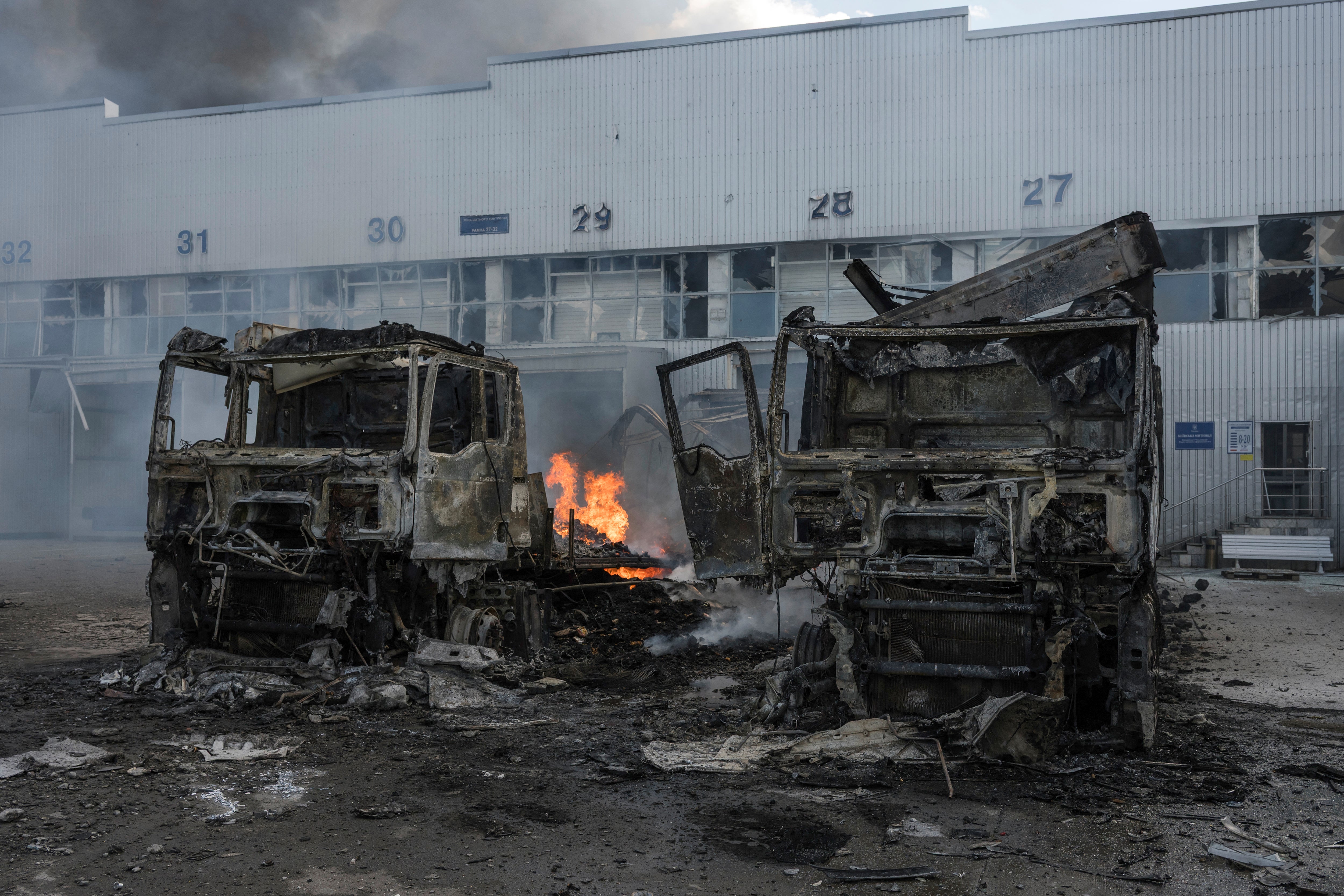 burnt-out trucks near a damaged auto parts warehouse following an air attack in Kyiv (AFP/Getty)