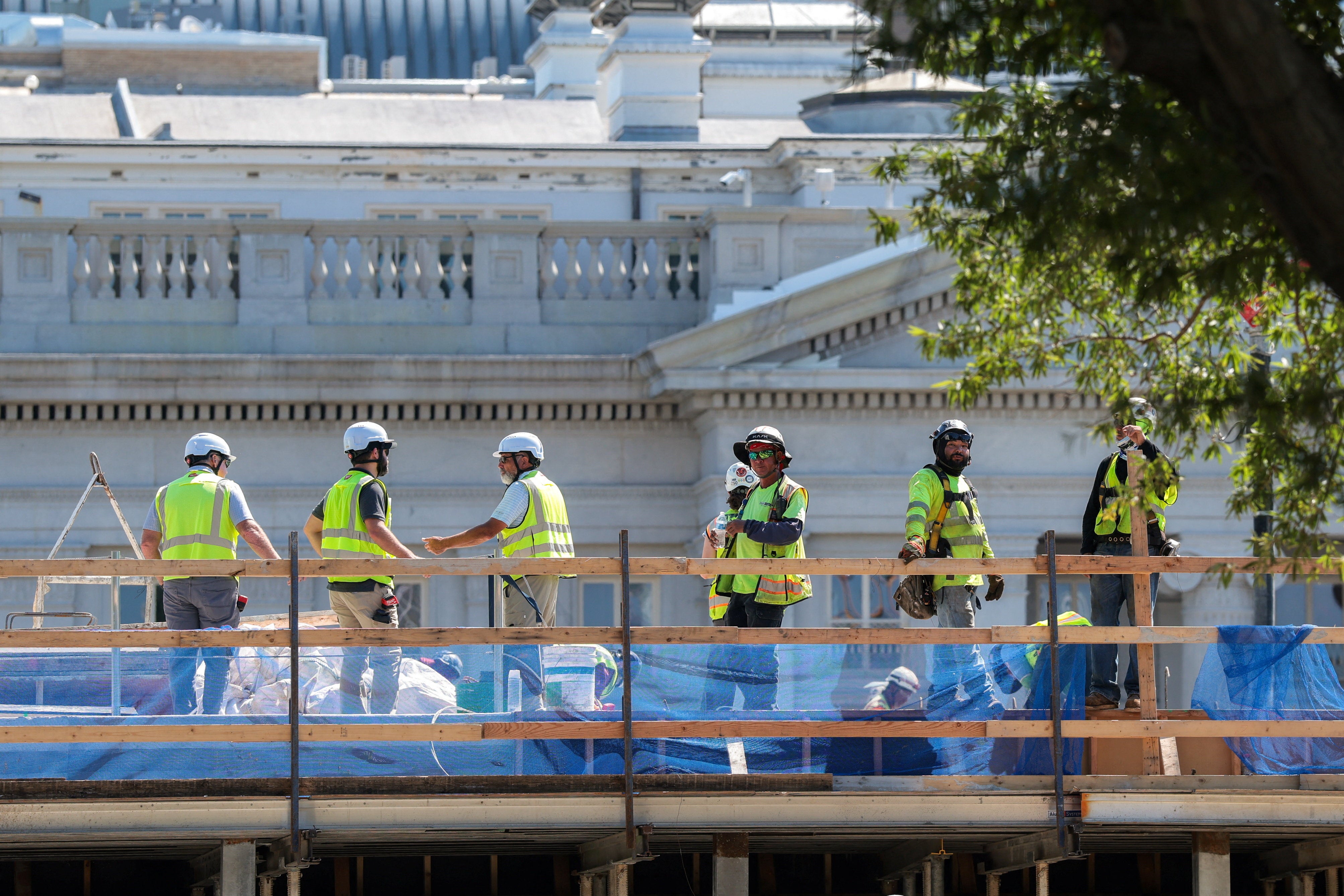Construction workers on the job at the planned White House ballroom site, where the East Wing once stood