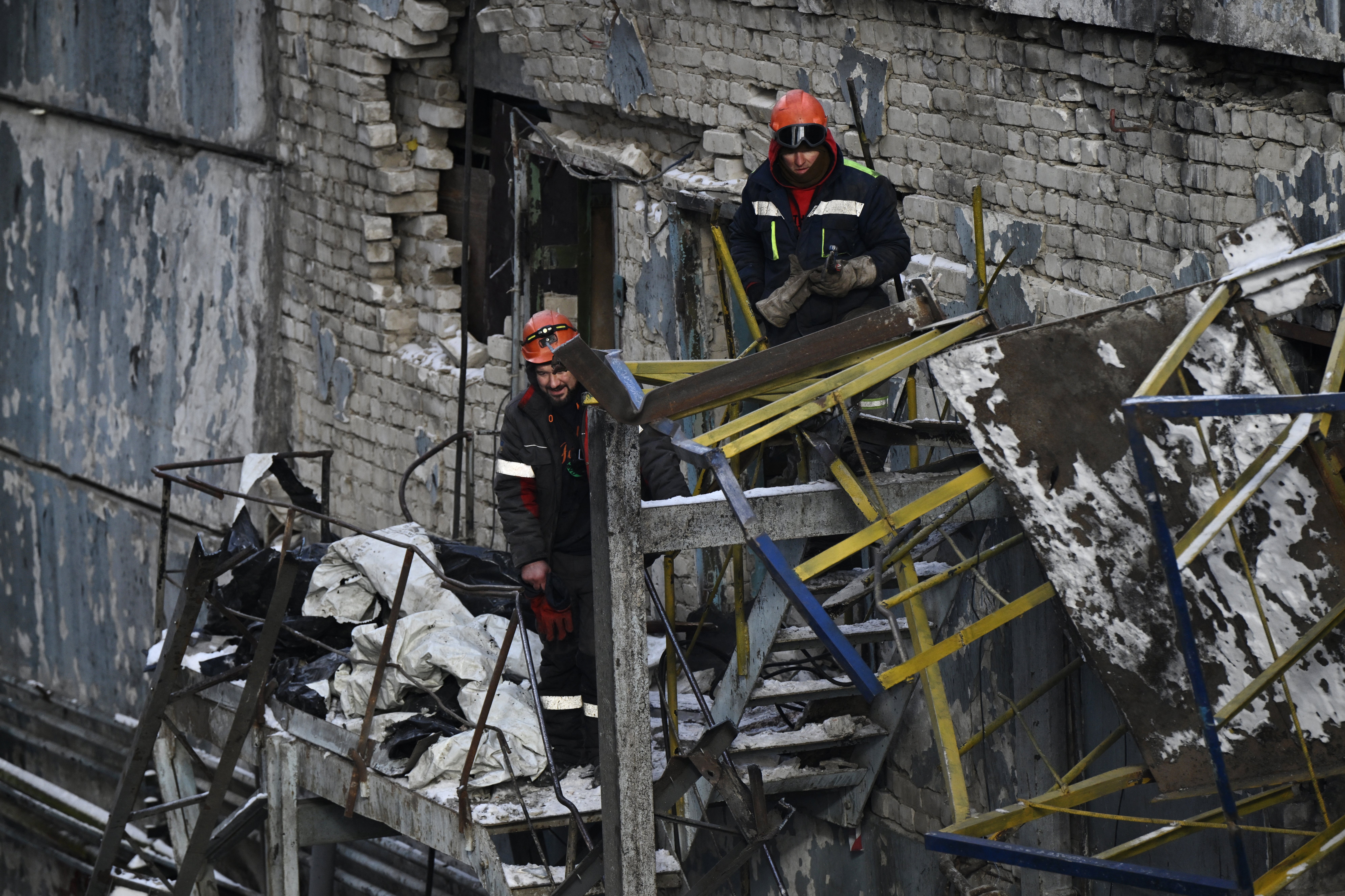 Employees clear debris at a heavily damaged thermal power plant in Ukraine following Russian missile and drone strikes (AFP/Getty)